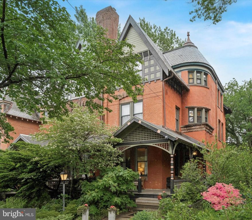 Welcome to this Historic Spruce Hill Queen Anne Victorian. A home filled with original details, and renovated with thoughtful, modern amenities. This 5 bedroom, 2.5 bath twin is part of the Chester-Regent
Historic District designed by famed Philadelphia architect Willis Hale and located on mature
tree-lined pedestrian-favorite blocks. The property is in prime location next to Clark Park, the
heartbeat of the neighborhood. Walk out your door one block away to visit the Farmer’s Market
every Saturday morning and popular Baltimore Avenue, with eclectic shops and dining. Hop on
the trolley at the corner, walk, or bike for a car-free commute to University City (Penn, Drexel,
HUP, CHOP, etc.) and downtown. 

As you enter the home, you will be greeted by a lush front garden leading up to the covered wraparound front porch, set back from the street. The historic wood-paneled entry vestibule with original mosaic floor tiles and William Morris wallpaper leads you into a formal entry hall with views of the staircase and a stunning carved wood newel post. Soaring 12’ high ceilings on the first floor, 10’ high ceilings on the others, and large updated windows fill the home with light and spaciousness. Original details abound such as 10’ high cherry wood pocket doors, plaster crown moldings, and oak flooring. A recently restored
working fireplace with original decorative tiles makes the living room the most delightful winter
cozy space. A powder room and storage for coats and shoes are discreetly tucked behind the
stairwell. The formal dining room provides plenty of space for entertaining. The modern kitchen
with stainless steel appliances and custom-made butcher-block top island opens to a cheerful
breakfast room that looks out through newly installed Andersen full glass doors onto a spacious
back garden. The front, rear and side gardens feature a range of mature shrubs, ornamental
trees, and seasonal rotation of delightful perennials and native plants, many acquired from
nearby Bartram’s Garden. 

The home has been modernized with newly installed central A/C, insulation blown into wall and floor cavities, 200 amp. elec. panel, tankless water heater, plaster repairs throughout, and laundry on the 2 nd floor. The bedrooms on the upper floors have been used for various functions, including a family TV room, office, and exercise space, all generously sized (200 sq. ft.) with closets. A former 2nd floor bedroom was converted into a large spa-like master bath suite with Kohler soaking tub, tiled shower, double vanity and plenty of closet space. 

An original 3rd floor bathroom features a clawfoot bathtub and pedestal sink.
There is ample storage space with a renovated, pristine attic space with skylight that brings light
through the stairwell. The basement is organized and accessible with high head-height and
newer clerestory windows. This home has been meticulously renovated and maintained by the
current owners and prior owner over the last 25 years with care and professional expertise. A
true gem and rare opportunity for a move-in ready forever home in Spruce Hill.