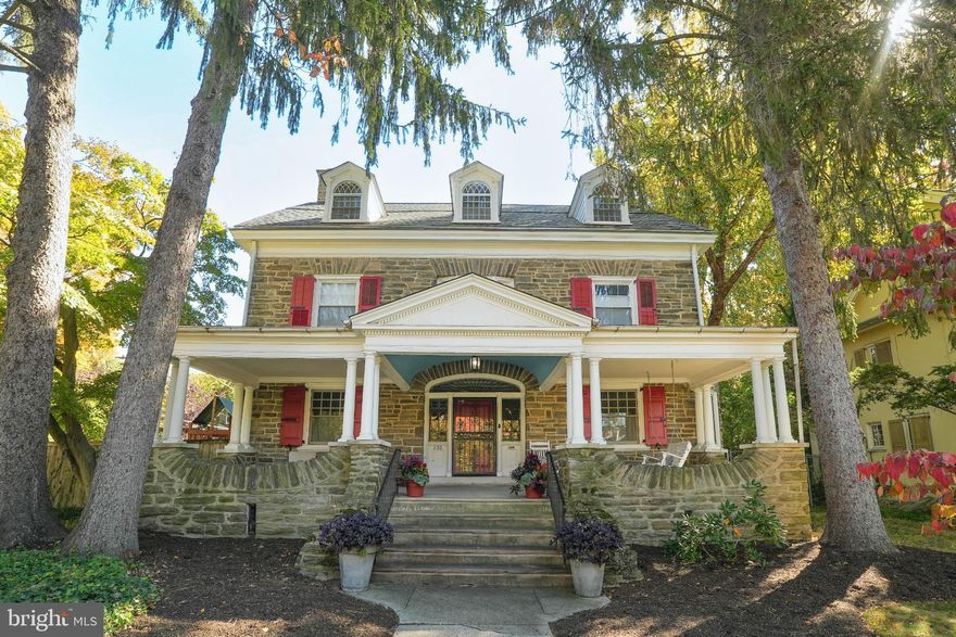 Welcome to this grand 3-story stone colonial, a true jewel of the historic Pelham neighborhood in West Mt. Airy. Built c.1895, this 6-bedroom, 2.5-bath home beautifully blends original architectural detail with thoughtful modern updates. Step into the stunning foyer where a sweeping three-story staircase, leaded glass windows, and ornate moldings immediately showcase the character of the home. The first floor offers a gracious flow, featuring a large formal living room with fireplace, a spacious dining room, and a cozy den or family room. The heart of the home is the expanded eat-in kitchen, renovated with high-end appliances including a Wolf range and Bosch dishwasher, abundant cabinet and counter space, and room for both everyday meals and entertaining. A powder room completes the main level. 

Upstairs, the second floor boasts a regal primary suite with a walk-in closet and ensuite bath featuring a soaking tub, shower, new tile floor, and double vanity. Another bedroom completes the floor as well as convenient, dedicated laundry room with newer washer and dryer. Additional 3rd fl bedrooms offer generous space that could suit multiple needs share a full bath. Perfect for an au-pair suite, office, or flexible space. 

Original details are found throughout the home, including pocket doors, fluted pillars, crown molding with dentils, vintage light fixtures, and deep window sills, complemented by original hardwood floors. Outdoors, enjoy a gigantic front porch with swing, a private back patio, and a beautifully landscaped fenced yard with perennial and specimen plantings—perfect for gatherings or quiet moments. Children's play area (playset included) as well as raised garden beds and a dedicated fire pit space are highlights. New Roof (Feb 2024), central air, and large waterproofed basement. Private gravel driveway that will fit two or more vehicles is accessible from Quincy St!

With a Walk Score of 86, this location is “very walkable” and just steps from Weavers Way, Germantown Avenue shops and restaurants, Carpenter Lane SEPTA station, Carpenters Woods, and Wissahickon trails. This remarkable Pelham residence is ready for its next chapter—move in, unpack, and enjoy!