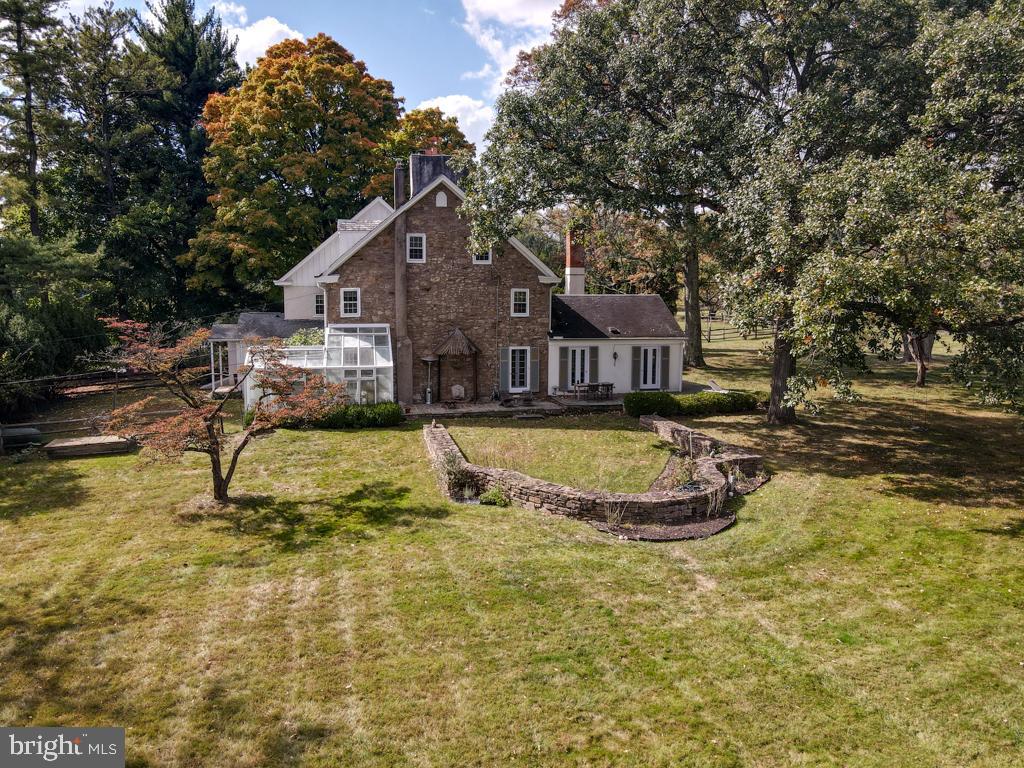 Uniquely charming, the Westside farm includes the original Westside farmhouse adjacent to historic Dawesfield, once home to Robert Morris, signer of the Declaration of Independence. Lewis Lane courses through largely preserved open space on a leafy country lane in the center of historic Whitpain. Five acres of sweeping lawn secures privacy and will easily allow space for a new addition or a completely new home and subdivision possibilities are indicated.
If you love history and a home oozing character, this opportunity does not come often. A newer kitchen addition with expansive glass allows for immediate possession and move-in. Come and tour the original wood floor spaces with architectural character in all sight lines. The floor plan includes five bedrooms, five full baths and a powder room. A living room, and sitting room with an old world cooking fireplace connect to a dining room and entry hall.