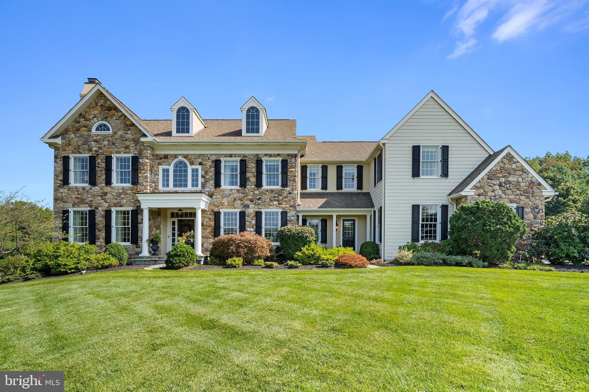 No detail has been spared in this updated and meticulously maintained stone front home which stately sits at the head of a of the cul-de-sac in the highly sought-after Whitegate community! The grand two-story foyer is flanked by large living and dining rooms which contain views and access to the enchanting back yard. The updated gourmet kitchen serves as the perfect place to entertain guests or relax with family and features a newly renovated, expansive kitchen with Sub-Zero and GE Monogram appliances, a wet bar, sun drenched breakfast room and renovated family room. Bright light streams throughout. Adding to the well-crafted design of the first level is a large home office/bonus room and newly remodeled family organization room equipped with a 2nd powder room and separate entrance to the outside and access to the 3-car attached garage. The second floor boasts 5 oversized bedrooms, 3 full baths and a 2nd floor laundry. The generously sized master suite contains a sun-drenched sitting area/office space, two large, outfitted walk-in closets and an oversized bath complete with a soaking tub, frameless shower, and private toilette. The fully renovated lower level is sure to be a delight to all! Featuring a Home Theater system with projector TV, a large custom-built wet bar equipped with a full-size refrigerator, microwave, dishwasher, warming drawer and ice machine. Additionally, a separate game room, full size gym, home office and full bath can be found. Double French doors provide additional light and allow for walk up access to the outside. The outdoor space is a true entertainer’s delight featuring extensive flagstone hardscaping and amazing living and dining spaces! Cozy up to the firepit or the custom bar all while overlooking the lush backyard. Stunning curb appeal, fully updated interior and exterior spaces and a cul-de sac location—this home truly has it all! Don’t miss out on a rare opportunity to live in this gorgeous, move in ready home! Conveniently located with proximity to downtown Wayne, major highways, and the King of Prussia Town Center.