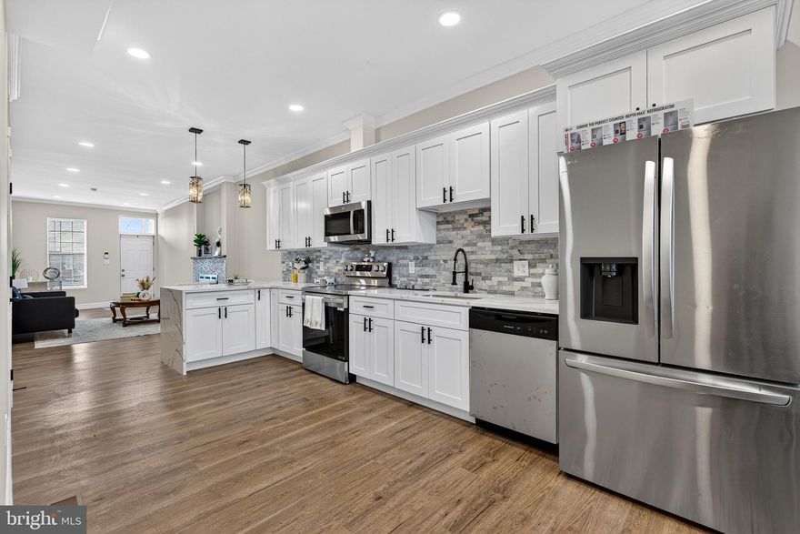 Welcome to this beautifully renovated home offering three fully finished levels of modern living in the heart of Baltimore City!  4 bedrooms, 3.5 bathrooms, The main level features an inviting open, concept layout highlighted by a stunning electric fireplace, perfect for relaxing or entertaining. The brand new kitchen, complete with quartz countertops, custom backsplash, peninsula seating, modern lighting, and sleek finishes, along with a convenient half bath. The second level boasts a private balcony and a primary suite alongside an additional bedroom, while the third level offers two more generously sized bedrooms with a full bathroom this is ideal for family, guests, or a home office setup. The unfinished basement provides abundant space and endless potential for future customization. Additional upgrades include new windows, dual HVAC systems, a new water heater, and updated electrical for peace of mind. fully fenced backyard. Don’t miss this incredible opportunity to own a move-in-ready home in a highly accessible Baltimore City location. Schedule your private tour today and make 1762 E North Ave yours!