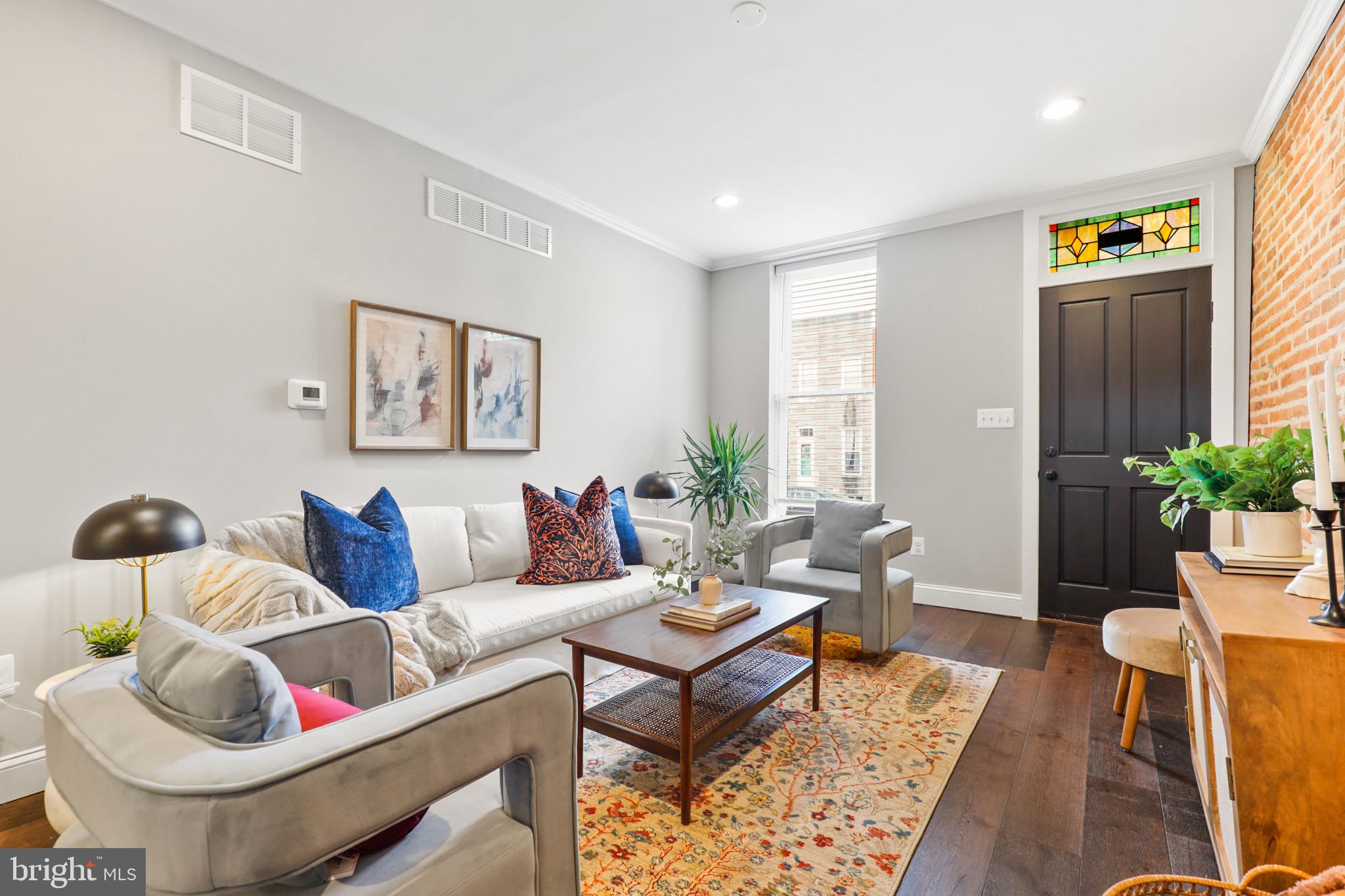 Nestled in the vibrant Locust Point neighborhood, this exquisite 4-bedroom, 3-bathroom townhouse offers a harmonious blend of historical charm and modern luxury. Built in 1875, the home resonates with Baltimore's rich history, while its recent updates provide all the comforts of contemporary living.
As you step inside, the warm embrace of natural wood flooring and recessed lighting welcomes you. The gourmet kitchen, a chef's delight, features stainless steel appliances, elegant countertops, and a convenient breakfast area. The open floorplan, accentuated by crown molding and built-in features, creates a seamless flow for entertaining and daily life. The home's thoughtful design extends to the finished basement, boasting a generous 440 sqft of additional living space, perfect for a family room or home office.
Upstairs, the bedrooms offer serene retreats, each with ample space and natural light. The primary suite features a luxurious bath, ensuring a private and peaceful haven. Additional amenities include energy-efficient appliances, a central air conditioning system, and a cozy backyard for outdoor relaxation.
This townhouse is a rare gem in Baltimore City, offering the convenience of off-street parking – a prized feature in the urban landscape. The property's brick construction not only adds to its aesthetic appeal but also stands as a testament to its sturdy and enduring nature.
Discover the perfect blend of historical elegance and modern comfort at 1410 Hull St – a home that promises a lifestyle of convenience, style, and tranquility in the heart of Baltimore.
