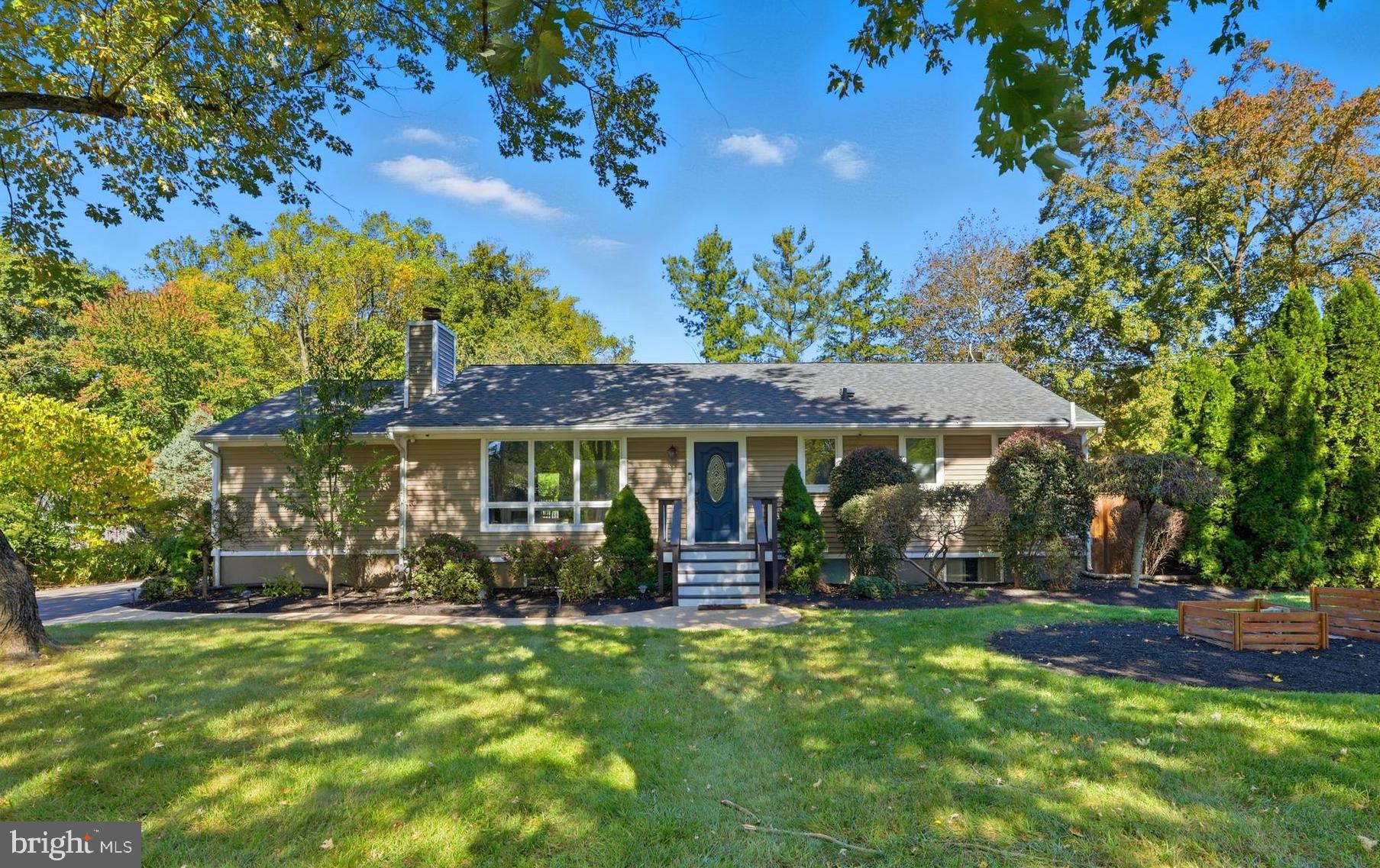 Welcome home! This private Annapolis retreat blends comfort and elegance, with dramatic high ceilings and main level living that feels both relaxed for everyday life and sophisticated for entertaining. Inside, discover an open floorplan with fresh paint, stunning vaulted wood ceilings, gleaming hardwood floors, and wide windows flooding the home with abundant natural light. The spacious and bright living room features a large picture window and recessed lighting, and is anchored by a striking double-sided stone gas fireplace flanked by built-in cabinets. Pass through the classic archway into the gorgeously updated kitchen (2021) featuring sleek marble countertops, new tile flooring, modern recessed lighting, and stainless steel appliances, including a high-end dual-fuel GE Café range with double oven (2021). With a central island breakfast bar and additional bank of cabinet storage, this spacious layout keeps the chef connected to the living and dining areas. Continue through the lovely glass pocket doors into the open dining and family room and be impressed by the custom vaulted wood ceiling, large windows and welcoming finishes. Down the hall, the rare main-level primary bedroom boasts a rich cathedral wood ceiling, newer plush carpeting, a cozy wood-burning fireplace that can easily convert to gas, and a unique two-level walk-in closet. Enjoy a beautifully appointed custom en suite bathroom with a luxurious oversized shower and a handsome vanity with a new countertop, sink, and faucet (2025). The second bedroom includes new soft carpeted flooring, ample closet space, and access to the second tastefully updated bathroom in the hallway. Downstairs, the lower level offers a versatile recreation room with brand new carpeting (2025) and a generously-sized storage room with built-in shelving. Two additional bedrooms and a third full bathroom with a step-in shower provide further flexibility for a private guest space, home office, or gym. Outside, enjoy an expansive wraparound and recently repainted wooden deck with built-in grill, and relax by the firepit in the privacy of nearly half an acre of fenced yard, surrounded by mature trees for a tranquil, scenic view. On the front of the home, the refinished driveway (2024) offers plenty of room for your boat or trailer. Recent major home updates include a newer roof (2022), geothermal energy-efficient HVAC (2019), upgraded Anderson doors and windows, whole-house water filtration with UV filters and a point-of-use reverse osmosis filtering sytsem, a 50-amp hookup for a potential hot tub, a gas line roughed for a future whole-house generator, replaced BAT septic system. Conveniently located just minutes to Giant, Annapolis Mall, Downtown Historic Annapolis, and Quiet Waters Park. Easy access to Route 50 and nearby commuter routes puts Annapolis, Baltimore, and the region within easy reach. Schedule a private showing to see everything this special home has to offer!