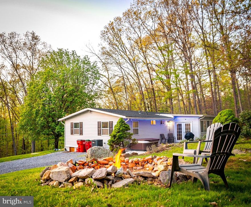 DON'T WANT TO MISS THIS ONE- this charming 3-bedroom 2-bathroom home with highspeed internet comes completely turnkey ready to move in or rent. It is located in close proximity to the Shenandoah and Potomac Rivers, Hollywood Casino at Charles Town Races, as well as many other attractions associated with the historic town of Harpers Ferry.  Come and enjoy all the area has to offer during every season of the year.  Within the subdivision is the 55-acre lake to enjoy swimming, fishing, boating or just the view itself. Mountain Lake Club at the lake offers a Bar & Grill within the subdivision also. This home, located within an hour of most of the DMV area, is all set for you to move in full time, use as your vacation get away, or to utilize as an investment rental property.  After a full day of enjoying the historic attractions or a local brewery or winery, you can relax in the included hot tub or sit under the stars by the existing campfire area.   This home, on just under an acre, is just the right size for you to take full advantage of your down time and not spend it doing house chores or mowing grass.  The home is currently being used as an Air B&B, and income records are available.
MORE PHOTOS TO COME