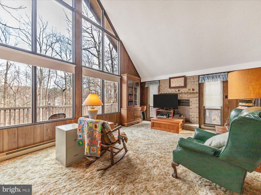 Fun get away at the Woods resort This A frame has a loft bedroom  and a main level bathroom and bedroom. Large open living room with a wall of windows to enjoy nature. Stacked washer and dryer stay. Galley kitchen with a bar for eating.  Range and refrigerator convey .   Inspections for buyers information only Seller is not in a position to make repairs due to health. There are several types of recreation  fees Seller has kept all current. Golf, 2 pools, hot tub. tennis and pickle ball courts. Trails and picnic area, lake with a small beach. Call The Woods office for more details 304 754 888  . Fireplace not working , gas or electric logs  and vent needed.