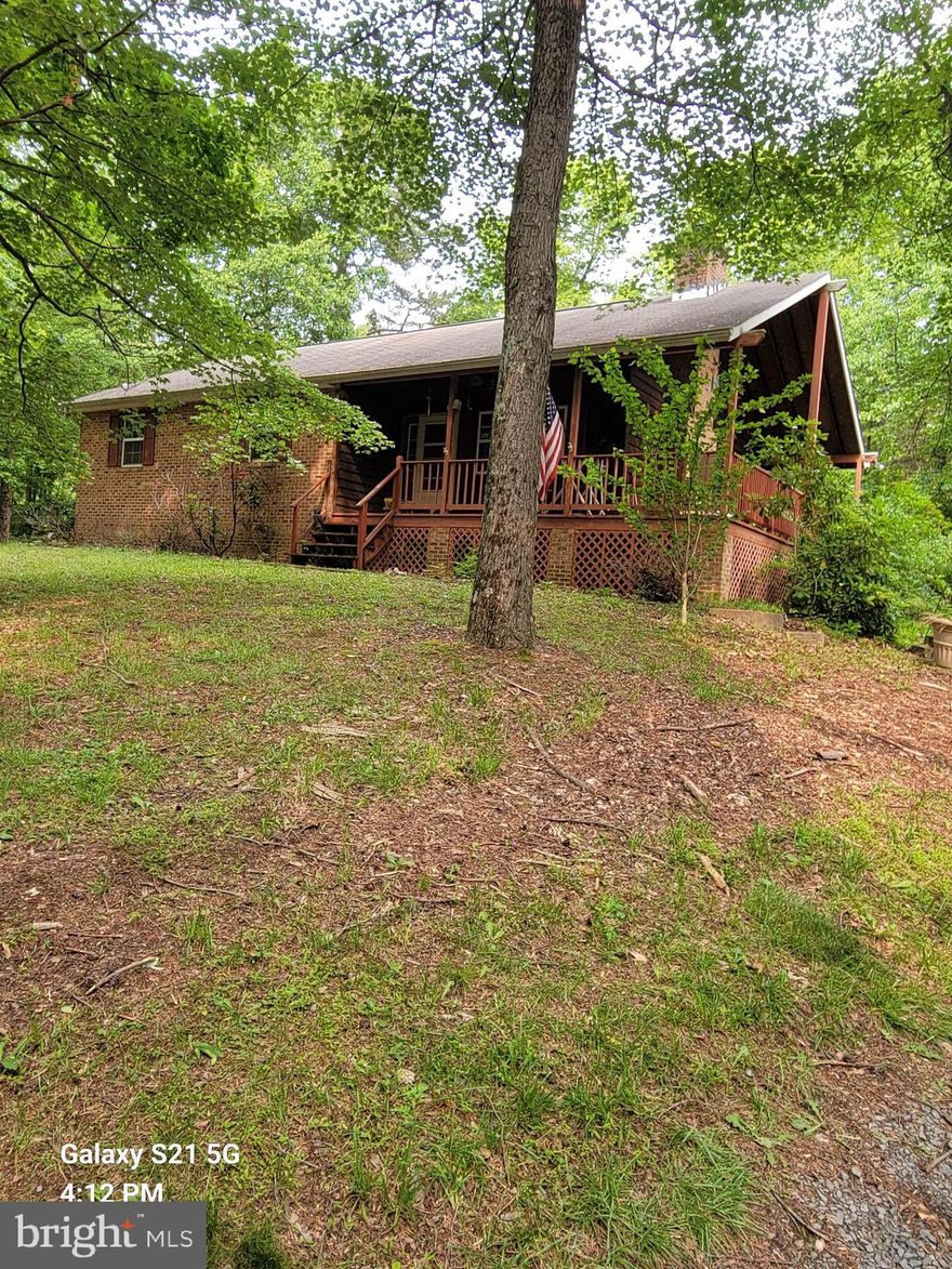 This 3 bedroom, 2 bath home on 2.12 acres is awaiting its forever family! Enjoy the evenings on the wraparound porch.  With some tlc this home could be returned to its former glory! 2 outbuildings are on the partially cleared/wooded lot.  This home has a shared well that is maintained by the HOA. Call today for your viewing!