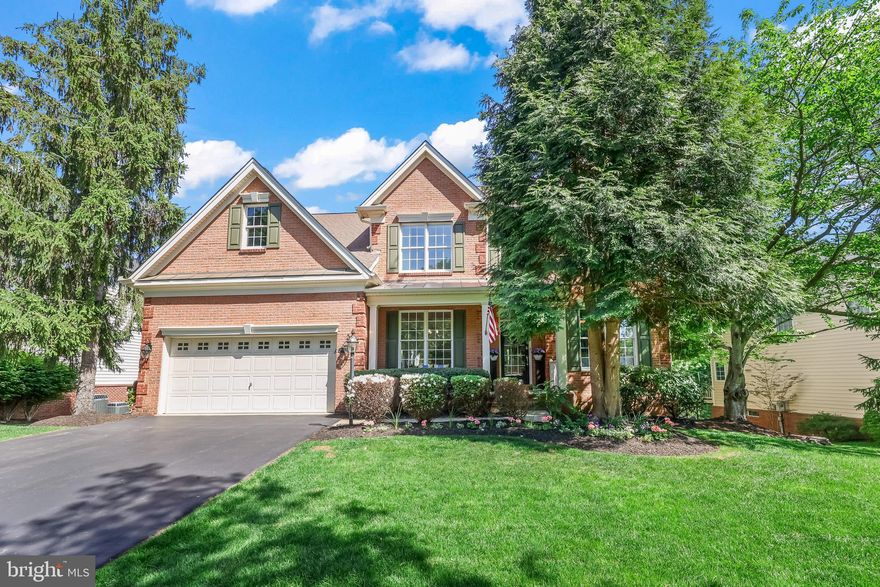 Stunning interior design meets a picturesque lot, with golf course views, at Dominion Valley Country Club. This 5 bedroom, 3.5 bathroom stunner, with over 4,700 sq ft,  sits on the pond, overlooking the golf course. You will be thrilled by the design choices in each room, as you see how the owners have blended beautiful form with function. As you step inside you're greeted with new lighting and carpeting in the sitting room & dining room, where you'll be delighted to host your next gathering. Make your way into your kitchen, complete with all new backsplash, stainless steel appliances, and a new oversized island that seats 5 comfortably. From here, step out onto your new TREX deck with inground lighting. On the upper level, the completely renovated primary ensuite boasts an extra large walk in shower, and free standing soaker tub. You'll find attention to detail in every room, from the entrance to the laundry room. Beautiful wallpaper accents walls, new lighting to include chandeliers and sconces, bring even more brightness to each space. The lower walkout basement level, is complete with kitchenette, full bedroom and bathroom suite, and a great flexible living area which is perfect for multigenerational living or potential income rental. You do not want to miss this beauty, in the gated Dominion Valley Country Club, which includes the golf course, country club, pool, playground, sports courts, and more. Schedule your private tour today, this one wont last long.