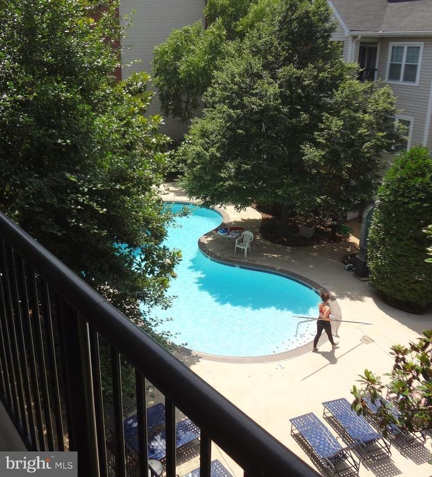 Updated 1 BR w/Spacious Double Balcony overlooking Pool! Large Renovated Kitchen w/Granite Counters/ Breakfast Bar.  Upper level unit with Vaulted Ceiling.  Freshly Painted and New Carpet. Amenities include: Gated Community, fitness center, Pool, FREE Shuttle to the Metro. Deeded Parking. Lower condo fee than the elevator buildings! (show instructions in agent remarks)