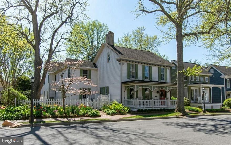 Ideally located in the heart of the St. Michaels Historic District, this beautifully maintained three-story home offers exceptional walkability just a half block from the waterfront, scenic walking trail, public park and kayak launch, as well as the shops, restaurants, and other amenities that make St. Michaels such a sought-after place to live. A welcoming front porch introduces an inviting interior with hardwood floors, multiple comfortable living areas, and four wood-burning fireplaces that add warmth and character throughout. The spacious layout includes four bedrooms and four and one-half baths, providing flexibility for everyday living and hosting guests, along with a dedicated office, custom built-ins, and abundant storage. Outside, the beautifully landscaped and fenced yard offers privacy and space for outdoor enjoyment, complemented by a detached studio/workshop ideal for creative pursuits or hobbies. Off-street parking adds convenience in this prime in-town setting. With a prime location, generous living and storage space, and historic charm, this distinctive property represents exceptional value in the heart of St. Michaels.