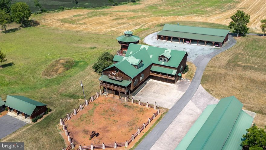 Setting, style, workmanship, versatility, and innovation all come together on one remarkable property. Opportunities like this are rare—where character, versatility, and income potential all come together on one remarkable property.


Set on just over 6 acres and zoned commercial/industrial, this one-of-a-kind property offers endless possibilities for business, investment, or a live/work concept. With multiple structures already in place, it’s ready to support a wide range of uses—from storage and distribution to event space, creative ventures, or specialty operations.


At the heart of the property is a stunning Amish-crafted barn, an impressive structure that combines scale and craftsmanship with soaring ceilings and incredible open space. Whether repurposed for business, events, or storage, it delivers both functionality and undeniable visual impact.


Equally unique and attractive is the converted silo apartment rising up 4 stories with wrap-around deck - a truly unforgettable living space featuring one bedroom and one bath, with panoramic views stretching across farmland and mountains. It’s currently generating income and offers a rare blend of charm and experience that tenants or owners will love.


The property also includes a 5,100+ sqft detached work building designed for productivity, complete with an office, bathroom, large storage bays, and a 15.5 ft oversized door for easy access. Insulated and heated, this space is ideal for year-round operations, equipment storage, or a variety of industrial uses.