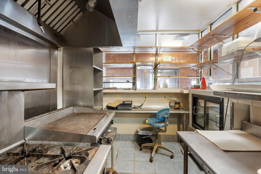 End-of-group mixed-use brick-front rowhome with income potential and charm! The main level is set up for a deli or restaurant, fully equipped and ready to go—with a convenient powder room for staff and guests. Upstairs, the residential space, which has a potential rental income of $1,500, offers an open layout with a spacious kitchen, island prep area, and room for both dining and entertaining. Natural light floods the living area through large windows. A bedroom, full bath with tub/shower combo, and laundry room complete this level. The top floor features two generous bedrooms and another full bath. Live upstairs and run your business below—or rent out one or both units for additional income! Prime location near Reservoir Hill, Druid Hill Park, Route 40, and I-83.