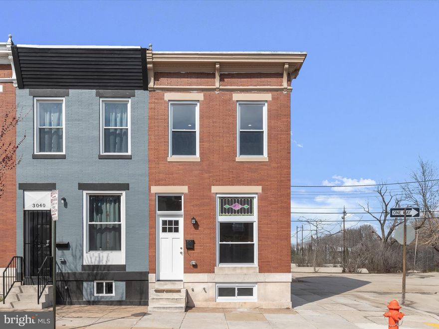 Charming, newly renovated end-unit brick colonial row home blending timeless elegance with modern updates! Step into the inviting living room, featuring stunning hardwood floors, recessed lighting, soaring ceilings, and exquisite stained glass accents. The dining room continues the rich hardwoods and offers built-in storage, perfect for displaying your favorite pieces. The beautifully updated kitchen boasts ceramic tile flooring, granite countertops, a decorative backsplash, stainless steel appliances, gas cooking, and soft-close cabinetry. Upstairs, you'll find two spacious bedrooms with hardwood floors, including one with built-in bookcases and access to a private balcony. The updated hall bath adds to the home’s appeal. The fully finished lower level provides a versatile space for recreation or a media center, complemented by ceramic tile flooring and abundant natural light. Enjoy outdoor living on the rear fenced patio. Conveniently located near I-695, I-95, I-895, and US-40 for easy commuting. Don’t miss this gem!