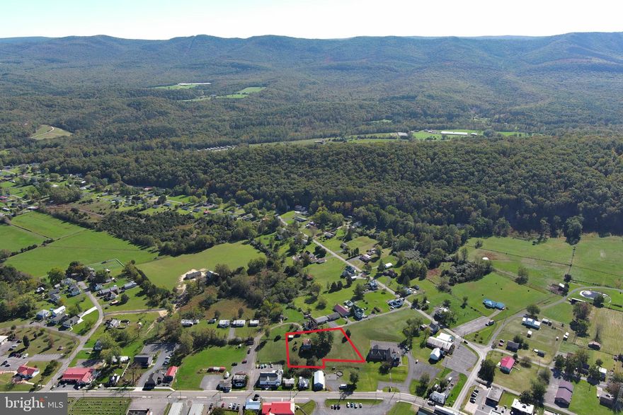 THE HOUSE ON THE HILL IN WARDENSVILLE......THE "HEISHMAN HOME" IS AN ICONIC PROPERTY IN THE TOWN OF WARDENSVILLE, SITUATE ON AN ACRE OVERLOOKING THE TOWN AND SURROUNDING MOUNTAIN RANGES. BUILT IN 1920 WITH AN EXTERIOR FACELIFT IN THE EARLY 2000'S.....VINYL SIDING, RE WIRED AND REPLACEMENT WINDOWS. THE INTERIOR FEATURES THE ORIGINAL HARDWOOD FLOORING AND TRIM WORK. AN EXCELLENT OPPORTUNITY AWAITS TO RESTORE THIS HOME TO IT'S FORMER GLORY FOR YOUR PRIMARY RESIDENCE OR A BED AND BREAKFAST. THE HOME UTILIZES PUBLIC WATER AND A SEPTIC SYSTEM, HOWEVER PUBLIC SEWER IS AVAILABLE. NOT IN TO FIXER UPPERS? THEN TEAR IT DOWN AND UTILIZE NEARLY AND ACRE OF PRISTINE LAND IN THE HEART OF TOWN. WARDENSVILLE IS THE NEW GATEWAY TO THE WEST AND THIS PROPERTY IS AT THE DOORSTEP!