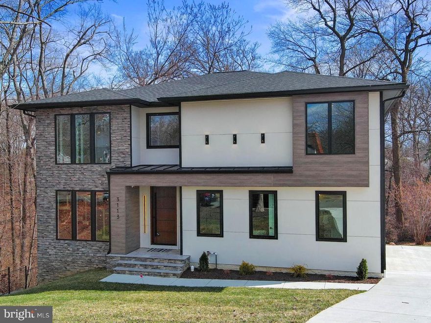 This spacious masterpiece of modern architecture is situated on a quiet, curving street in the desirable George Mason School district and offers privacy, proximity, luxury, and functionality on one of the nicest streets in Alexandria. The property is a 20-minute drive to the Capitol, 10 minutes to Old Town, and a short walk to the fun and excitement of Del Ray. The home takes full advantage of its location on .32 acres adjacent to Alexandria City’s 15-acre Monticello Park.  Monticello Park has been named a Community Forest by the Old-Growth Forest Network, a designation that protects the park from future development. Drawn by the stream, ample trees and green space, the park is a stop for more than 30 species of warblers on their annual spring migration, as well as orioles, finches, wrens, thrushes, flycatchers, and many more. 

In the home, the abundance of nature is highlighted by large windows that afford magnificent views.  Appointed with high-end materials and cutting-edge design, the home has six bedrooms, including a main-level ensuite bedroom/office, and six and a half baths. The elegant, modern floating staircase with thick oak treads connects the three levels, giving the home an open, airy feel.  The 9’ ceilings throughout the home enhance the spacious ambiance. The heart of the home is the kitchen, with its oversized island, large pantry, top-of-the-line Thermador appliances, luxurious quartz countertops, and designer tray ceiling. There is a mudroom with custom built organizers for daily storage!  Double sliding-glass doors lead to the private rear deck overlooking the park, making this a place where people will want to spend precious time together.  Just off the kitchen is a mudroom with custom designed organizers to maximize space and day-to-day storage.

Upstairs are four large ensuite bedrooms, including the primary bedroom which occupies the entire rear of the house, providing stunning park views through oversized casement windows. The primary bedroom is a luxurious escape from the day-to-day, with a beautiful designer tray ceiling, and a large walk-in closet (14’3” x 13’3”). The list price includes a $10,000 credit for design and construction of your dream closet! The luxurious primary bath features a floor-to-stone ceramic tile shower surround, custom double vanity, rain shower, body spray (seven shower heads in all), and a freestanding soaking tub.   

The sixth bedroom is located on the lower level with an adjacent ensuite bath and spectacular views of the park.  The spectacular lower-level media room is prewired for projection and high-speed digital service and features custom lighting and a riser for two- seating.  The lower level recreation room is the ideal place to entertain or just relax, with a walk-behind wet bar custom cabinetry, quartz countertops, a wine cooler, and an ice maker. A sliding glass door leads to a covered patio overlooking the park. The house is prewired for internet, including a video security system, and features three heating and two cooling zones.  

Unlike any home in the area, 3113 Circle Hill blends modern luxury with unparalleled proximity, making this property the perfect home for anyone drawn to luxurious living in Alexandria City among the birds and trees.
