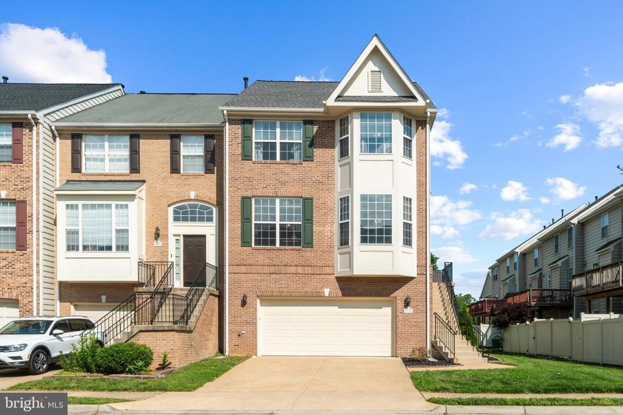 **Offer Deadline is Monday 6/6 at 12noon**Beautiful end unit, brick front, updated townhome in sought after Belmont Bay.  Enter this gorgeous home to find an 18' two-story foyer, hardwood flooring  and 9' ceilings throughout the main level.  A beautifully painted dining area greets you to the left with crown molding, bay window and updated chandelier with ceiling medallion and Edison bulbs.  The adjoining kitchen was renovated in 2019 featuring a  functional Peninsula style kitchen that opens to dining room,  that can double as a breakfast nook, quartz countertops, matching Whirlpool stainless steel appliances, beautiful mosaic backsplash and soft close inserts. Continue on this level to a living area with a ceiling fan and unique three sided fireplace.  There is also access to a deck from this level.  Upstairs find two spacious bedrooms, an updated hall bath  with new vanity and luxury vinyl flooring plus the primary suite.  The  primary bedroom includes walk-in closet, ceiling fan, window treatments, carpet, an ensuite bathroom offering an upgraded vanity, free standing soaking tub, freestanding shower stall with recessed lighting and luxury vinyl flooring. The hardwood stairs lead down to the basement and offer an open living area, full bath, laundry room and sliding glass door out to the fenced in backyard.  All in an amenity rich neighborhood offering a community pool, walking trails, marina, community events and more!  Easy access to Rt. 1, I-95, shopping, dining and walking distance to the VRE.