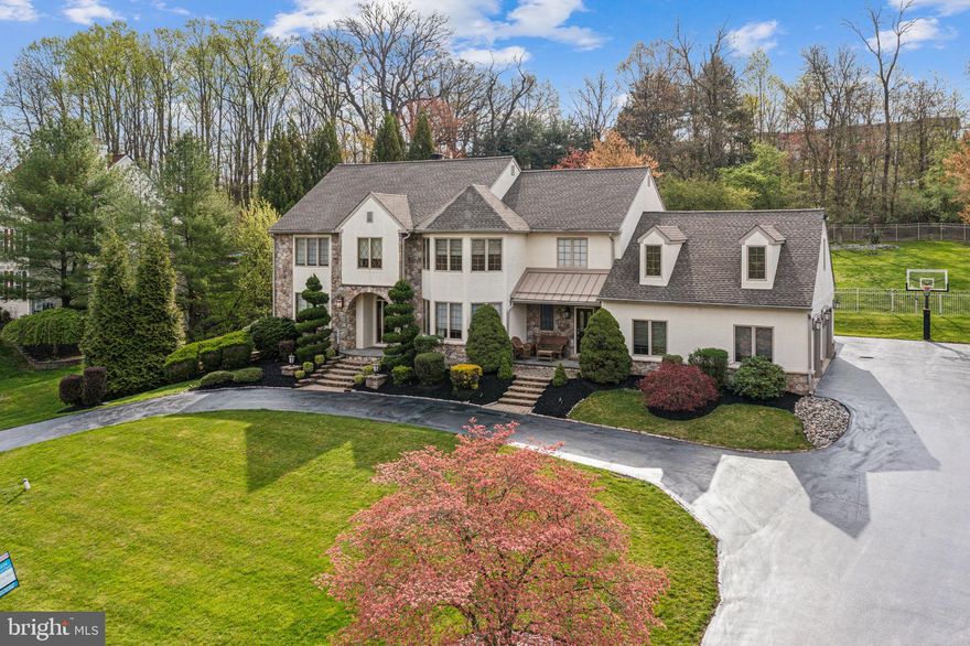 Back on the market with a price improvement! Seller to provide stucco report and remediation to be completed. Nestled amongst the lush trees lining a cul-de-sac in Middletown Township's quiet Heilbron neighborhood, you'll find 576 S Heilbron Dr. This custom, 4,800 SqFt home offers 4 bedrooms plus a large bonus room, 4 full and 2 half bathrooms, a 3-car garage, an expansive finished basement, a sprawling backyard, and placement in the top-rated Rose Tree Media school district. Out front, meticulously kept landscaping, a curved driveway, and a prominent facade combine for picturesque curb appeal. A stone archway leads to an entry foyer with the main staircase, a powder room, and a coat closet. To the left, French doors open to a sunny sitting room, while a formal dining room lit by bay windows is on the right. Both showcase inlaid Brazilian cherry hardwood floors that continue throughout the home. The sitting room connects to an office, anchored by a gas log fireplace. At the center of the home is a bright and airy 2-story family room framed by soaring cathedral ceilings with skylights and intricate hardwood floors. Rich millwork trims a wall of windows, while a towering stone fireplace adds warmth. Past a breakfast room, the gourmet kitchen has lots of custom cabinetry, high-end stainless steel appliances, including a double range, granite counters, a tile backsplash, a butler's pantry, and an island with seating. This level is completed by a mud room off the garage and a laundry room with a secondary entry. A rear staircase leads to the second-story hallway that overlooks the family room. Hardwood floors stretch into the palatial primary suite, where tall windows displaying views of the backyard pour in natural light. A multi-sided fireplace helps create separate sleeping and sitting areas. The walk-in closet feels like a department store, while the luxurious spa-like bathroom is adorned with radiant heated tile floors (found in all the bedroom bathrooms) featuring a distinctive design, dual vanities, a soaking tub, and a glass-enclosed shower. A huge bonus room sits above the suite, perfect for a gym, office, and hobbies. Elsewhere on the second level, a pair of spacious, carpeted bedrooms are adjoined by a Jack-and-Jill bathroom, and a bright bedroom suite has its own full bathroom. Down in the home's finished basement, there's an entertainer's paradise with a custom bar, full bathroom, and plenty of space to hang out. In addition to everything inside, the home's fenced backyard and patio is sure to be your go-to spot for barbecues, al fresco dining, gardening, playing, and relaxing in the hot tub all spring and summer. 576 S Heilbron Dr's fantastic location, just off Rt-1, is minutes from The Promenade At Granite Run and Riddle Hospital. There's also easy access to Downtown Media and Rt-476. Schedule your showing today!