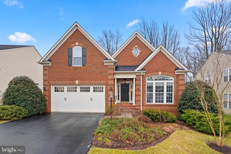 Welcome to this spacious colonial home nestled within the vibrant 55+ community of Stonecrest in Arnold MD. This gorgeous 2007 built, 4 bedroom, 3 bath home is situated on a premium lot overlooking wooded privacy. Step inside and be greeted by a meticulously designed interior that exudes warmth and sophistication. The attention to detail of this timeless floor plan is evident throughout, with beautiful hardwood flooring that flow throughout the main level. high ceilings and crown moldings that add a touch of luxury. Tall windows flood the space with natural lighting. Prepare to be impressed by the kitchen which is a chef's dream. This updated kitchen features stainless appliances, granite countertops, center island with extended breakfast bar, beautiful cabinetry and spacious pantry. The adjacent dining area provides an ideal setting for formal dinners or casual gatherings of any size and opens to a warm and inviting family room just perfect for gatherings and relaxation that is centered around a gas fireplace. Entertaining and relaxing will be effortless on your deck and screen porch that overlooks wooded privacy. It's the perfect spot for morning coffee or an evening with friends and family. The main level primary suite is a sanctuary of luxury with tray ceiling, sitting area, and deep walk in closet. The en-suite luxurious bath features soaking tub, shower with bench seating, separate vanities and private water closet. Two additional main level bedrooms with shared full bath are generously sized and well situated for privacy. Ascending the staircase, you'll be greeted by private bedroom area, with living space and full bathroom just perfect for guests. Need more space? This home boasts an expansive finished lower level with walk out. This versatile space can be customized to suit various needs, such as a recreation room, home theater, or fitness area with potential for an extra bathroom and 5th bedroom. The spacious 2 car garage includes a wheel chair lift that for accessibility, and independence. Community amenities include trail and gazebo. Located just moments from downtown Annapolis and the Naval Academy, Stonecrest provides easy access to Rt 50, shopping, dining and services. Welcome home!