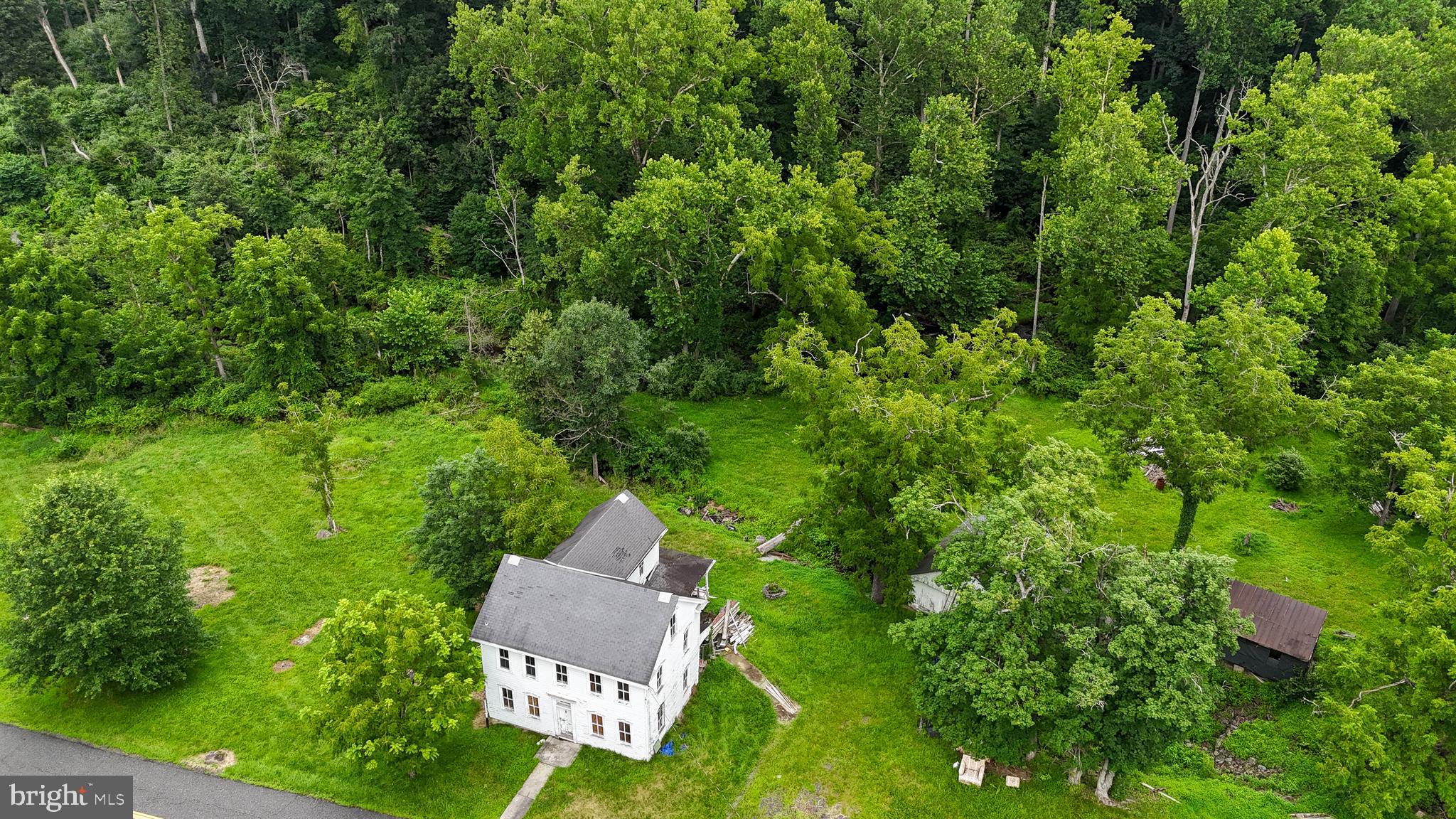Looking for a place to get away or to build a beautiful new home? Start new, Rehab this 1850 home, or find a different way to use it. This 7 acre property offers a discrete location with the peace and quiet of nature all around. An Old Grist Mill and a homestead still remain. Renovate the house or start new. The dwelling is down to the studs and some renovations were done a few years ago. (For serious buyers interior pictures available on request.) Please do not access property without permission. Some of property is in a flood zone. Schedule a showing today and start planning your ideas.