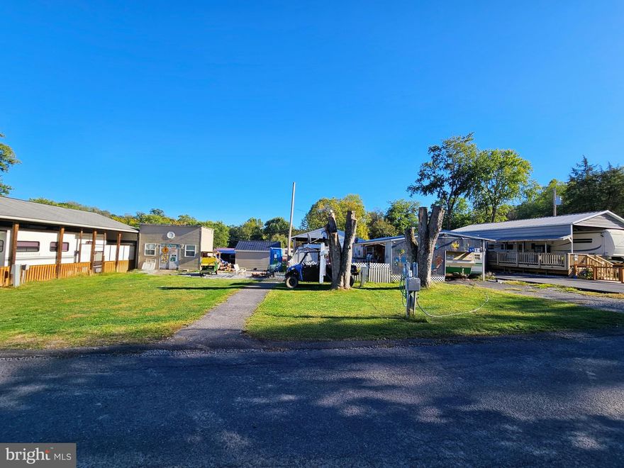 Welcome to Block 6 lots 6 & 7 Poison Oak in Riverbends Rv Campground. Riverbend is 400 Acres of SEASONAL recreational campground full of amenities located on the Potomac River in Falling Waters, Wv. OPEN APRIL 1 - NOVEMBER 1 - This is a fun & entertaining community, yet relaxing.
Here we have 2 lots for the typical price of one! Which gives you extra parking (Highly desireable) These 2 lots are flat and have 2 paved driveways, plenty of room for extra parking and storage to leave the boat and all they toys. Built over the camper is a 12 * 12 ft covered porch with electric, fans and lights on a dimmer & a newer metal roof with an additional 12 *25 deck spacious enough to host all of your friends & family. Built on, connected to the primary full-size bed & bathroom of the camper you'll find extra living space as well as a kitchen set up with a cooktop, counter space, extra cabinetry, window A/C unit and more. (Sink needs connected).  Off of the primary bedroom is a twin bedroom with extra storage and through to the kitchen with a full-size refrigerator and living room with a futon for even more sleeping space. The camper has 2 window units for A/ C.  Wired inside and out are 2 speaker systems that convey. All the Patio furniture also stays.  The storage shed has electric and a refrigerator. This lot is also partially fenced in yard for the pups. Lot 6 is flat and perfect for extra parking and has plenty of room to bring another camper if you desire. It has a nice size storage shed with electric and a full-size bed for extra sleeping. 
 Call today for your personal tour.
 Approx. 10 miles of Deep water on the Potomac River access for boating, fishing & swimming. Yearly membership ($1,987) plus a $200 initiation fee for new owners, includes water, sewer & Pump outs, electric, trash and the park amenities such as 3 pools, putt putt course, Horseshoe club, Boat club, Poker runs, Trick or Treat, Christmas in July, live bands, basketball court, tennis court, fireworks, car show, Church, restaurant, bar, convenience store (Great food), playground, volleyball, ball field and much much more. Bring your golf carts, water toys and come enjoy life!