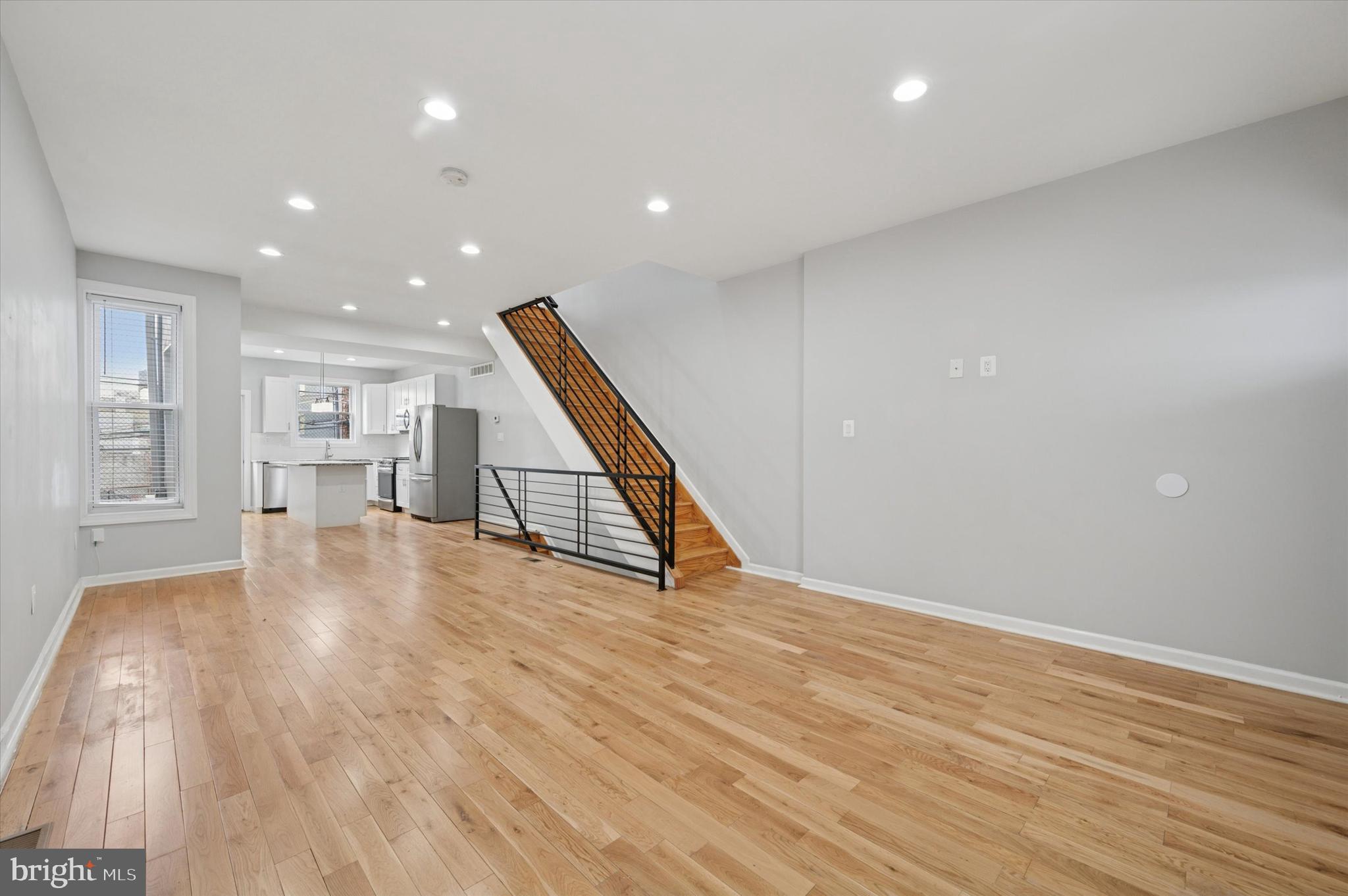 Welcome to 3024 Redner Street, a beautifully renovated 3-bedroom, 1.5-bath home located in the heart of Brewerytown—one of Philadelphia’s fastest-growing neighborhoods. From the moment you arrive, the curb appeal stands out with a freshly painted façade, a covered front porch, and sleek black metal railing. Inside, you’re welcomed by an open-concept main level featuring refinished solid hardwood flooring, recessed LED lighting, and a modern black metal staircase railing that adds a stylish contemporary touch. The spacious living and dining areas flow seamlessly into a bright, modern kitchen equipped with granite countertops, a large center island, white shaker cabinets, subway tile backsplash, pendant lighting, and a full suite of stainless steel appliances including a gas range, microwave, dishwasher, and French-door refrigerator. A rear door leads to a private outdoor space, perfect for grilling or trash storage. Upstairs, you’ll find three comfortable bedrooms, each with hardwood flooring and ample closet space. The front primary bedroom offers a bay window and double closet, while the rear bedrooms provide flexibility for a guest room, home office, or nursery. The full hallway bath is beautifully appointed with large gray tile, a decorative mosaic accent band, a standard soaking tub with rainfall showerhead, and a modern white vanity. The fully finished basement is a standout feature, offering additional living space with eye-catching multi-tone tile flooring, a half bath with a floating vanity, and a dedicated laundry area with Samsung washer and dryer. This level provides the ideal setup for a media room, home gym, playroom, or guest suite, with mechanicals tucked away behind a utility closet and glass block windows providing natural light. Additional highlights include central air, forced heat, newer windows, updated electrical and plumbing, and a fresh, neutral paint palette throughout. Just blocks from Fairmount Park, ALDI, local breweries, coffee shops, and public transit, 3024 Redner Street is a turnkey property offering space, style, and convenience in an unbeatable location. Whether you're a first-time buyer, growing household, or investor, this home checks every box. Schedule your private showing today.