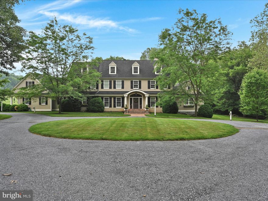 Where land and luxury meet - 100 Woodfield Crossing is a custom, private home located within minutes of downtown Lancaster. This one-of-a-kind colonial estate, built by Kreider & Diller has three stories with 5 bedrooms / 6 baths, 2 half baths and is nestled on 7 exclusive acres. Upon entering the foyer, you will be mesmerized by the grand curved stairs and stunning cherry softwood floors. Throughout the home, you will find beautiful DMM woodworking, including all cabinets and built-ins. No detail has been overlooked, including the coffered ceilings throughout the entire first floor in the living and dining rooms, kitchen, study, and primary bedroom. Recessed lighting brightens up every room, with complimentary 6” baseboards throughout. The large, beautiful kitchen is any chef’s dream. With beautiful granite and marble from Natural Stone Works, soft-close cabinetry with underlighting, a woodblock worker’s island, a gas-top range, and Jenn Air refrigerator, and a built-in mixer stand, this kitchen is a must-see. Off of the main kitchen is an additional walk-in pantry with storage, a third sink, and an ice maker. A luxurious half bath with marble flooring and vanity top and an antiqued mirror is conveniently located on the main floor for guests. As you enter the massive living room, you will appreciate the 9’ ceilings, wood-burning fireplace (which can easily be adapted to gas-powered), oversized bay windows, and large custom entertainment and bookcase. With two dining rooms to choose from, both the formal and informal provide space to entertain while keeping an intimate atmosphere. The main floor, primary bedroom and ensuite offer a tranquil escape with spa-like finishes and crown molding throughout. The owner’s suite comes customized with built-in speakers, in-lay lighting, and private patio access. The ensuite is breathtaking with floor-to-ceiling tile, an oversized walk-in shower with multiple shower heads and jets, a soaking jetted tub, dual custom vanities, and a custom beauty vanity. The primary walk-in closet puts Carrie Bradshaw to shame with sliding pocket doors, custom DMM woodwork, and three full-length mirrors. Off of the primary bedroom is a private den with an additional wood-burning fireplace. On the main floor, you will also find a study, laundry room, and a smaller secondary office - as well as access to the secondary staircase. The attention to detail is something you must see in person to truly appreciate. As you head to the second floor, there is a beautiful loft that sits a the top of the grand staircase with a built-in wet bar and mini fridge, a perfect hangout spot. There are an additional four bedrooms and three baths, all with stunning features and top-of-the-line finishes, including a laundry chute at the end of the shared hallway. Above the attached three-car garage is a gym that is ready to be finished into an in-law suite with a full bath, cork flooring, storage and closet space, and rough-ins for a kitchenette. With its own private entrance and a third stairwell leading right to the mudroom on the main floor, this space is prepared to be finished with exceptional detail.     The walk-out basement has been partially finished with storage, a kitchenette and bar, and a game room. There is an additional full bath with a walk-in shower and granite details. Natural light floods the finished space access to the outdoor living area. The unfinished portion of the basement is the workstation of the home with dual water tanks, water softener, paint storage, crawl space, and a central media hub with the Sono’s system that is integrated throughout the entire home.     This one-owner home comes stocked with a buried 500-gallon gas/ propane tank, on-site irrigation well, Sonos system, 6 outdoor security cameras, an entire home speaker system, a central vac system - with three hoses included, screens for every window, and has 9’ ceilings throughout. The entire home, except the gym, is geothermal