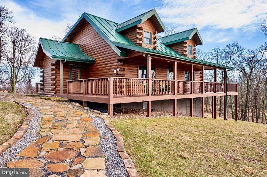 Welcome to your stunning Amish-built pine log cabin mountain retreat, where panoramic mountain views await from the wrap-around deck! Bask in the abundance of natural light that fills this meticulously maintained home. Set on 14 acres of picturesque landscape, this retreat features 4 bedrooms, 2.5 bathrooms, and a fully finished basement. With a 3-car garage, beautiful hickory hardwood floors and cabinets, high-speed fiber optic internet, and an in-home surge protection system, every detail has been crafted for your comfort and convenience. Experience the perfect blend of rustic charm and modern luxury in this idyllic getaway. Less than 20 minutes to Moorefield for shopping, dining/cafes. 25 minutes to Wardensville for organic farmers market, bookstores, and dining/cafes. 2 and 1/2 hours to D.C. Make an appointment today!