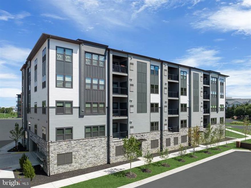 Take advantage of our FINAL home left for Feb 2024 move-in and come home to luxury lock and leave living! This open 2B/2Ba + den elevator condo flat with covered balcony is located on the highly desirable TOP FLOOR, in a secure elevator building with assigned parking space in the covered garage below. The 9' ceilings and extra windows of this coveted corner unit allow an abundance of natural light in. High end designer finishes such as 9" wide plank LVP flooring, stunning quartz countertops, shaker-style cushion-close cabinetry, designer glass backsplash with oversized farmhouse sink will have you showing it off to friends and family. Relax in your spa like owner's shower with glass enclosure and upscale Emerge shower column, tile ledge and tile floor. This home is just steps from the up and running Herndon-Monroe metro station with direct route to DC and an easy stroll to grocery and dining, and less than a 10 min drive to the popular Reston Town Center. It is also close to all major commuting routes such as 28, 267 toll road, Fairfax Co Pkwy, etc. Act now to schedule an appointment. This opportunity will not last! Photos are of model, unit similar.