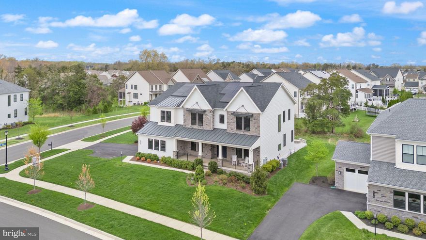 Welcome to 24562 Mountain Magnolia Place, an elegant and expansive home tucked in the sought-after Lenah Mill community of Aldie, Virginia. With over 6,800 finished square feet, 5 bedrooms, and 6.5 bathrooms, this home offers the perfect blend of luxury, comfort, and thoughtful design.
A formal dining room sits just off the foyer, while the heart of the home—a gourmet kitchen—features an oversized quartz island, stainless steel appliances, gas cooking, tile backsplash, and a huge walk-in pantry. The spacious eat-in area flows into a bright living room with a gas fireplace. Just off the living room is a main-level office, along with a guest suite complete with a private full bath. A large mudroom connects to the 3-car garage for everyday ease. Upstairs, the luxurious primary suite offers a peaceful retreat with a sitting area, a large walk-in California Closet, and a spa-style bath with a freestanding tub and oversized shower. Each additional bedroom has its own ensuite bath, and the upper-level laundry room is both spacious and functional. A versatile loft adds extra space for a playroom, office, or media area. The finished basement includes a large rec room, full bath, walk-up access to the backyard, and two unfinished spaces—one with an egress window, ideal for a future bedroom, and the other for storage. Outdoor living shines with a charming front porch, a screened-in back porch with retractable panels, and a lower-level stone patio with a built-in fire pit—perfect for entertaining year-round. The Tesla solar panels offer energy savings without compromise. Enjoy access to Lenah Mill’s resort-style amenities, including a clubhouse, fitness center, pools, courts, trails, and community events—all within a top-rated school district and just minutes from shopping, dining, and major routes. 24562 Mountain Magnolia Place offers elevated living in a vibrant, connected community—welcome home.