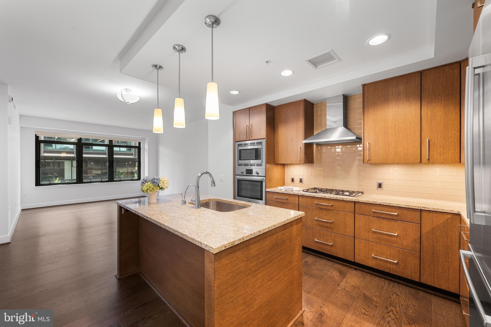 The home has been freshly painted and is move-in ready! Imagine living in the Darcy at this price! Immerse yourself in an urban lifestyle in the Heart of Bethesda! This luxury condo in a boutique building, built in 2015, offers high end finishes, lots of room, and even an EV CHARGING STATION installed by the owner in your dedicated parking space! The sun-drenched home features beautiful hardwood floors and an open flexible layout. The gourmet kitchen is equipped with Bosch stainless steel appliances, upgraded counter tops with bar seating, and ample storage including pull out shelving. You will find yourself at home in this spacious two bedroom, two bath unit. The primary bedroom features a large walk-in closet with organizers by California Closets and a spa-like ensuite bath. The second bedroom is conveniently situated to be used as a guest space or den. Please note, while the second bedroom is considered a legal bedroom, there are no windows. There is also an additional beautifully appointed full bath with a linen closet. This home also features a nice size laundry room/storage area. Find out what luxury living is like in a building that offers many amenities. Just across the hall you will have access to the large community area where you can entertain friends or just go outside for a cup of coffee. The 24-hour concierge service is enjoyed by all the residents. The building’s on-site management and in-unit maintenance services are additional perks. The top-of-the line fitness center features a fully equipped gym with a Peloton and even a yoga room! Love to grill? The shared space at the sister building, The Flats, offers you roof-top access with grills and a fire pit! Company coming to town? You may want to take advantage of one of the two in-building guest suites! And best of all you have immersed yourself in Bethesda Living. Take advantage of the Capital Crescent Trail (just across the street) for hiking and biking. Or perhaps you prefer Bethesda Row with its high-end retail and fine restaurants. For work or pleasure, the Bethesda Metro is just three blocks away! What are you waiting for? This home could be yours!