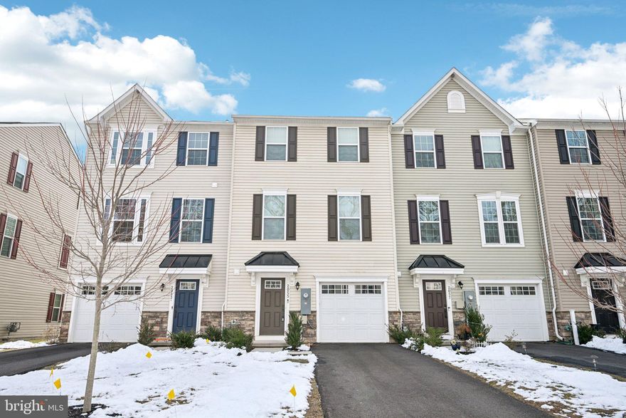 Welcome to Whitewood Village, where style, comfort, and convenience come together in this beautiful, turn-key, four-year-young townhouse. Lovingly maintained and used only as a second home, this residence offers a truly pristine interior and exterior with modern finishes and an abundance of natural light throughout its spacious three-story layout. Enter inside the ground level and you’re greeted by a welcoming foyer—perfect as a drop zone for coats, shoes, and bags. This level also features a convenient half bath, interior access to the one-car garage, and a versatile living room with sliding doors leading to the rear outdoor space. Upstairs, the main level showcases a bright, open-concept floor plan designed for today’s lifestyle. The expansive family room flows seamlessly into the eat-in kitchen, complete with high-end, energy-efficient stainless steel appliances, a generous island with seating, ample cabinetry, and a pantry for added storage. The dining area is perfectly positioned and features sliding doors that open to a private, south-facing deck—an inviting space for morning coffee or evening gatherings. The third floor offers three spacious bedrooms, including the primary suite with a walk-in closet and a private ensuite bath featuring a walk-in shower. Two additional bedrooms share a full hall bathroom, and the conveniently located laundry area completes this level for everyday ease. Ideally situated with easy access to shopping at Christina Crossing, a variety of dining options, nearby parks, and the University of Delaware. Commuters will appreciate quick access to I-95 and Route 1, making travel to Wilmington or Philadelphia effortless. Mortgage savings may be available for buyers of this listing.