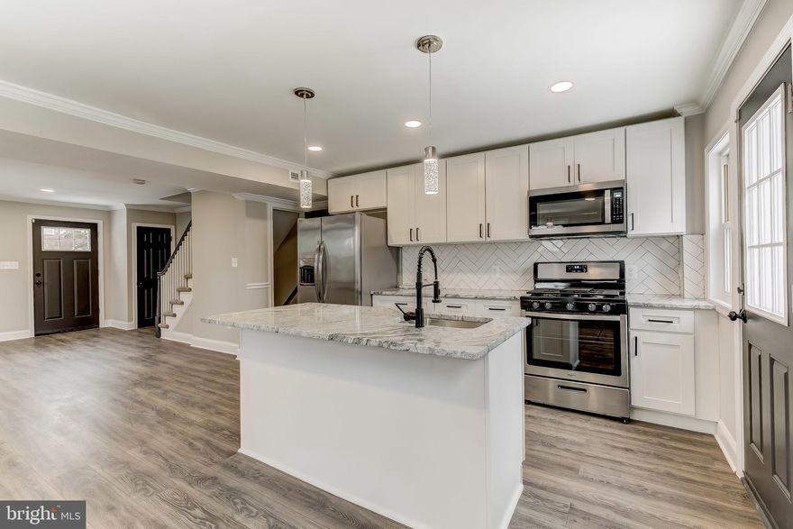 MULTIPLE OFFERS RECEIVED, H & B are due by 8 pm 2/10/21. Welcome to this Beautifully Renovated EOG townhouse with stylish finishes located in a well established neighborhood, a bright OPEN floor plan with Modern Amenities and a custom wall paneling. New designer Kitchen w/ Granite Countertops / Subway Herringbone pattern Backsplash / Island/ New SS appliances. Brand new FLOORING throughout the house. New ROOF, New HVAC, New HWH & Sump Pump, New Bathrooms with Custom Tile work & so much more. Electric 100% Fully Rewired, Recessed LED lights. FULLY Finished Basement has LVP waterproof flooring and a Full Bathroom and with Rear entrance. Brand new DECK and Fenced backyard great for entertaining. No detail has been overlooked. Tons of Natural Light, Conveniently Located.  This house is located directly across from the MORGAN STATE. Convenient  to Towson, Downtown , JHU, Morgan state, Lake Montebello.  A great home for all. ALL PERMITS PULLED & INSPECTIONS PASSED.