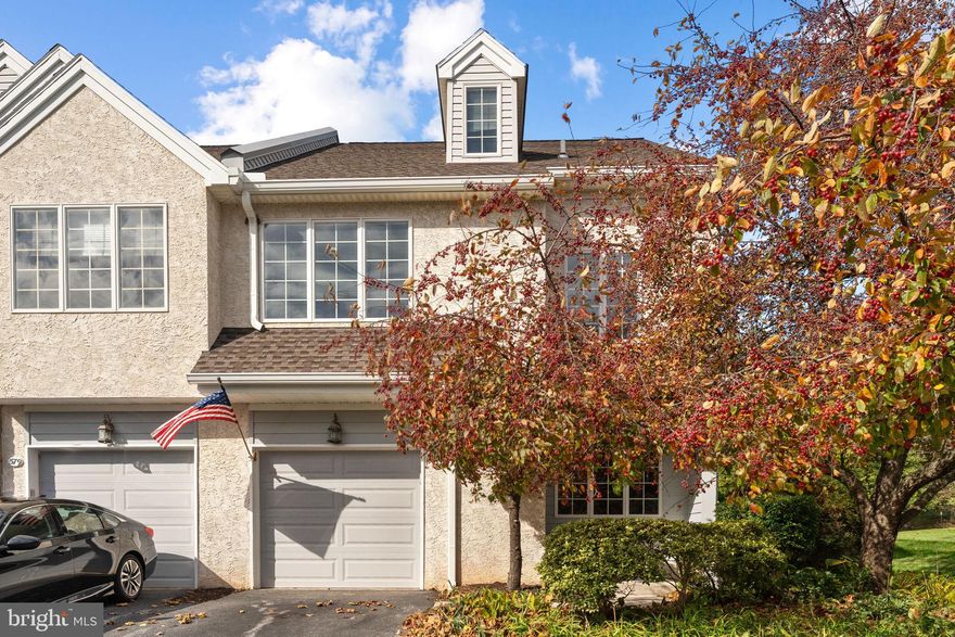 Welcome to 577 Pewter Drive — a move-in-ready, end-unit townhome in the sought-after Evian community in Exton. Step inside from the covered front porch to a tiled entry with coat closet. The spacious living room features a wood-burning fireplace and ceiling fan, while abundant natural light pours in through the extra windows unique to this end unit. A wide cased opening leads to the dining room, where French doors open to a private rear deck — perfect for morning coffee or a peaceful evening beverage. Mature trees provide privacy from the Whitford Country Club Golf Course, with just enough of a glimpse of the 9th fairway beyond. The updated kitchen is thoughtfully designed with generous cabinet space, granite countertops, tile backsplash, stainless steel GE Profile appliances, and a peninsula with breakfast bar seating. A convenient powder room and interior access to the one-car garage with electric opener complete the main level. Upstairs, the primary suite offers a bright and airy retreat with a ceiling fan, large walk-in closet, and a spacious en-suite bathroom featuring a soaking tub and step-in shower. Two additional well-sized bedrooms — each with hardwood floors and ceiling fans — share a full hall bath. The second-floor laundry closet adds everyday convenience. The third-floor loft, also finished with hardwood floors and a ceiling fan, includes a closet and offers versatile space for a fourth bedroom, home office, fitness area, or media room. The unfinished lower level provides excellent storage or the opportunity to finish for additional living space. Located in the award-winning West Chester Area School District, this home offers easy access to all that Exton has to offer — including shopping, dining, and major commuter routes. Available immediately and ready to welcome you home.