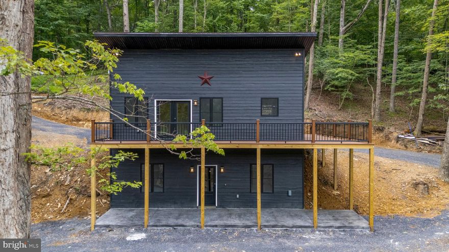 ***BACK ON MARKET THROUGH NO FAULT OF PROPERTY OR SELLER***Modern Mountain Retreat in the Heart of George Washington National Forest.

Nestled on 2.3 private acres in the breathtaking George Washington National Forest, this modern-style home is the perfect getaway for nature lovers and outdoor enthusiasts. With a small stream running through the property and direct access to miles of hiking and exploring, the location is truly ideal. Minutes from Trout Pond Recreation Area, enjoy swimming, boating, and paddleboarding, while also being just 25 minutes to Lost River State Park and 45 minutes to Bryce Resort, a four-season destination for skiing, golfing, and more. The charming town of Wardensville is just minutes away, offering farmers markets, shopping, and dining.

Designed for comfort and efficiency, this home features LP SmartLap siding for durability, a 50-year metal roof, and a maintenance-free wraparound Trex deck with railing—perfect for enjoying the peaceful surroundings. Enjoy relaxing on the concrete stamped patio on the lower level or sitting by the beautifully designed fire pit as the sun sets in the evenings. The home is pre-wired for a hot tub and an electric car charger installed, with ample parking space for convenience.

Inside, the modern rustic design shines with sage green soft-close cabinetry, granite countertops, and Catskill Pine LVP flooring throughout. The upper living area boasts pine board ceilings, an inviting fireplace in the living room, and a cozy breakfast nook/reading nook. The main-level bedroom offers ease of access, while the lower level features two additional bedrooms and a spacious rec room, complete with storage under the stairway.

Whether you're looking for a full-time residence or the perfect weekend retreat, this home offers modern amenities with a rustic touch, all in a prime location for adventure and relaxation. 
Owner is licensed agent in WV/VA