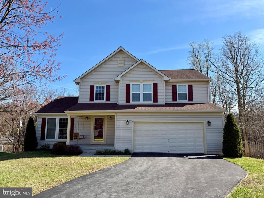 Welcome to this beautifully updated 4-bedroom, 2.5-bath home with a 2-car garage, ideally situated on a quiet cul-de-sac in Elkridge. The main level offers a spacious family room with a cozy gas fireplace, a bright sunroom filled with natural light, a formal living room, dining room, and a convenient half bath. The stunning kitchen features brand-new quartz countertops, stainless steel appliances, and a center island—perfect for both everyday living and entertaining.  Upstairs, the primary suite includes a walk-in closet and an en-suite bath with double sinks. Three additional generously sized bedrooms and a full hall bath complete the upper level.  The finished lower level provides exceptional flexibility with multiple bonus rooms—ideal for potential guest rooms, a home office, fitness space, or hobby areas—along with a large laundry room.  Enjoy outdoor living with a charming front porch with swing, a composite deck, a paver patio, and a fully fenced backyard that backs to trees for added privacy.  Recent updates include brand-new carpet on the upper and lower levels (2026), luxury vinyl plank flooring throughout most of the main level (2026), quartz kitchen countertops (2026), new kitchen sink and faucet (2026), fence (2024), washer and dryer (2024), refrigerator (2025), range (2024), patio (2021), dishwasher (2020), roof (2017 – CertainTeed Landmark 40-year), HVAC system (2017), and updated light fixtures (2026).  This is one you don't want to miss!  Open houses are scheduled for Saturday, April 18th & Sunday, April 19th from 12-2 p.m.!