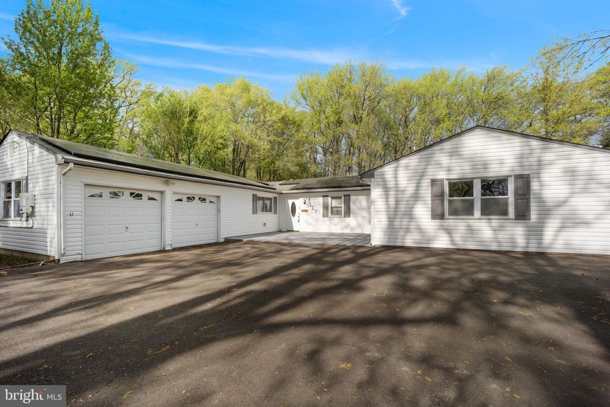 Large 4 bedroom 2 full bath expanded rancher with oversized attached 2 car garage and huge great room addition off the back with slider to parklike  background backing to mature trees.  Nice cirular driveway outfront that could fit several cars outfront. Nice size front patio leads to Foyer entry or enter through oversized 2 car garage. Tiled foyer, kitchen & hallway that leads to 4 good size bedrooms.  Country style kitchen has plenty of cabinets and counter tops besides patry closet. Nice breakfast bar with opening to Dining area plus kitchen fits it's own table space. Newer stainless steel applainces including side by side refrigerator & dishwasher. Matching stainless oven with flat glasstop range.  Laundry room with tub off kitchen leads to gararge and makes a great mudroom.  Dining room with custom ceiling fan open to living room with cathedral ceiling.  There are custom doors with full glass on back of living room that lead to great room addition. Massive great room with corner wood burning fireplace and slider to rear patio.  Master bedroom with primary Bath & walkin in closet long with large 2nd bedroom with plenty of closet.  3rd and 4th bedroom are a good size. 4rd bedroom looks over backyard and would make an excellent office for home work area if needed.  Full hall bath.  The two previous additions on original home made this a good size home with almost 2,300 square foot of living space on one level. Nice two car garage is oversized and has plenty of shelving and room for work area.  Minutes from Street Rd exit of I95 on large lot in established desirable neighborhood in Bensalem.