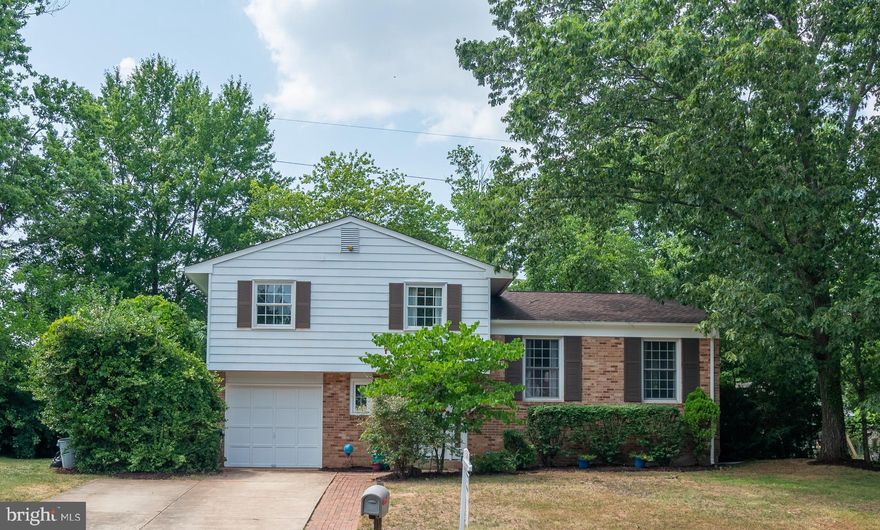 Welcome home!  This beautiful split level home has 4 spacious levels of  living, boasting  5 bedrooms 2 full & 1 half baths and garage!!  Perfectly designed multi-level living... walking through the front door the large foyer welcomes you along with a cozy family room and fireplace.  Through the family room you will find the laundry/utility room, a recently updated half bath and access to the 5th bedroom with it's own access to the backyard.  Move up a level and the home opens up with a recently updated kitchen featuring granite counter tops, new stove, refrigerator and microwave.  Hardwood floors run throughout the separate living and dining rooms.  Continuing upstairs you will discover 4  spacious bedrooms, including the master with two recently updated full bathrooms. Not to mention plenty of storage room in the basement.   The fenced in backyard features a deck/patio with access into the house through the kitchen.  Great location from Old Town Manassas with shops and fine dining.  Convenient access  to I-66, Rte 28 and Rte 234 and public transit/commuter lots and VRE.