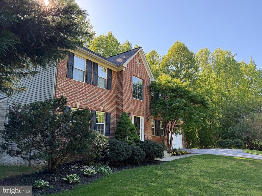 There’s something special about a home that just feels right the moment you arrive—and this stunning brick-front residence in Huntingtown delivers exactly that.

From the striking two-story foyer to the rich 5” cherry hardwood floors that flow throughout the main level, every detail invites you in with warmth and intention. The layout unfolds effortlessly, offering a refined sitting room and an inviting family room complete with built-in speakers and a beautiful Vermont Castings pellet stove, creating the perfect setting for both quiet evenings and lively gatherings.

At the heart of the home, the kitchen is designed to bring people together. Featuring granite countertops, a large center island, 42” cabinetry, and stainless steel appliances, it offers both style and function in equal measure. Sunlight pours through the windows and sliding glass doors, creating a bright, open atmosphere that naturally connects to the dining space and outdoor living beyond.

Upstairs, the owner’s suite becomes your private retreat. Vaulted ceilings elevate the space, while two walk-in closets provide room to breathe and stay organized. The spa-like bath invites you to unwind with a large oval soaking tub, a glass-enclosed shower with built-in seating, and elegant ceramic finishes that create a sense of everyday luxury. Additional bedrooms are generously sized, offering flexibility for family, guests, or work-from-home needs.

The lower level opens up even more possibilities. With LVP flooring, a spacious recreation area, full bath, and a large bedroom, the fully finished walkout basement is ideal for guests, extended living, or creating the ultimate entertainment space. The oversized double-wide areaway—with just four easy steps to grade—makes moving in and out effortless and enhances the home’s accessibility in a way you rarely find.

Step outside and you’ll discover a space designed to slow life down. The composite deck with vinyl railings overlooks a peaceful, private setting—perfect for morning coffee, evening conversations, or simply enjoying the quiet. Beyond the deck, the beautiful backyard offers endless opportunities for recreation, play, and making memories, with plenty of open space to enjoy plus a shaded wooded retreat featuring a playset that creates the perfect spot for adventure, relaxation, and outdoor fun.

Behind the scenes, the home offers true peace of mind with propane heat, a newer roof, a 6-year-old HVAC system, and a recently replaced well expansion tank—giving you confidence that the big-ticket items are already taken care of.

With 5 bedrooms and the potential for a 6th, 3.5 bathrooms, and a layout that balances openness with purpose, this home offers more than just space—it offers a lifestyle.

If you’ve been waiting for a home that combines comfort, function, and that unmistakable feeling of “this is the one”… you just found it.