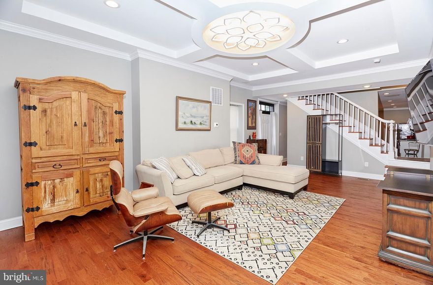 Inquire about renting it fully furnished, if needed.  This fully renovated home (2021) combines historic charm with thoughtful modern updates. Inside, you'll find three generously sized bedrooms, each with its own private en suite bath, beautifully styled with contemporary finishes. A centrally located second-floor laundry room adds convenience and function. The main level offers a spacious living room with a decorative ceiling, flowing into an open kitchen and dining area. Hardwood floors, granite countertops, a large kitchen island, and stainless steel appliances make this space ideal for entertaining or everyday living. A half bath and a handy mudroom at the rear of the ground level open to a private fenced backyard—perfect for pets, gardening, or relaxing outdoors. Situated just a block and a half from Union Square Park, this historic neighborhood is known for its welcoming community and engaging events calendar. Commuters will love the quick access to downtown Baltimore, local train stations, and major highways to Washington, D.C.