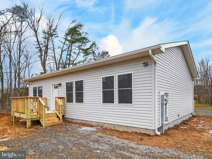 *** NEW CONSTRUCTION*** Discover peaceful country living in this brand-new ranch-style home nestled on a beautiful wooded 2.3-acre lot in scenic West Virginia, just 35 minutes from Winchester, Virginia.

This thoughtfully designed 3-bedroom, 2-bath home offers the perfect blend of modern comfort and natural surroundings. Step inside to find a spacious living room and kitchen featuring stunning vaulted ceilings that create an open, airy feel—ideal for both everyday living and entertaining. The 9-foot ceilings throughout enhance the sense of space, while 6-inch exterior walls provide superior energy efficiency and year-round comfort.

Enjoy your morning coffee or host weekend cookouts on the rear deck—perfect for grilling or simply relaxing and taking in the peaceful wooded views.
Additional highlights include:

•
