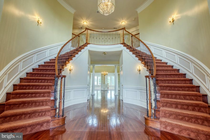 ACCEPTING BACK UP OFFERS!! This exquisite Toll Brothers Malvern model, is one of the largest homes in stately Chase at Belmont Country Club, an enclave of luxury estate homes in Ashburn. Experience the grandeur of the home as you enter the driveway with a double car garage on each side. This well-appointed Northeast facing home is located on a gorgeous .56 acre lot with 8849 square feet of living space and offers 8 spacious bedrooms and 6.5 bathrooms. Soaring ceilings, exquisite moldings, gleaming hardwoods, an abundance of windows, designer touches, impressive craftsmanship, extensive landscaping and an exciting floor plan are just some of the many highlights of this home. Whether you like to entertain with friends and family or spend a cozy evening at home, this multi-generational home will comfortably allow you to do both! 
The grand, curved double staircase with wrought iron balusters will impress as soon as you enter the home.  Elegant, formal dining and living rooms open lead into the bright Sunroom. Enjoy beautiful sunsets overlooking lush plantings. The main level also offers the much coveted office room and a large bedroom suite with an attached bath and walk in closet. Gourmet Kitchen with the Palladian addition has upgraded 42” cherry cabinets, granite countertops, large island, gas cooking and a walk in pantry and is perfectly suited for creativity and efficiency. The kitchen flows into the breakfast area and the large family room with the fireplace and a wall of windows. The grand conservatory addition adjacent to the family room is spectacular! 
The upper level offers 4 spacious bedrooms. The primary bedroom suite includes a den, two large walk-in closets, a separate dressing area and a master bath with a private toilet area, a separate shower, a Roman tub, and dual vanities. 2 other bedrooms share a Jack and Jill bath and the 4th bedroom has a private en-suite bathroom. All secondary bedrooms include spacious closets.  All bathrooms have cherry cabinetry.
With over 2800 sqft of space, the enormous walk out basement offers endless options for living, entertaining and storage. The full size windows in the 3 bedrooms brings plenty of natural light in and offers a view to the lush backyard. 2 full bathrooms, a kitchenette, third fireplace, second laundry closet and numerous closets for storage is sure to please the most discerning eye! 
The backyard oasis has been lovingly landscaped and will provide spectacular blooms throughout the year. The sprinkler system ensures that the lawn is lush and green. The maintenance free deck off the kitchen is the perfect hangout spot.  Enjoy the walking path beside the home which connects to the W&OD trail. Pride of ownership shines through in every little detail of this well maintained, gorgeous home and will provide years of enjoyment. There is over $100,000 in builder and owner upgrades throughout the home plus another $200,000 in the finished basement. 4 zone hvac, palladian kitchen extension, hardwood flooring throughout most of the main level, sunroom and conservatory additions, multi level bump outs, upgraded molding package, siding  and more. There are 2 laundry hookups - one of the main level and another in the basement. The home is also wired for audio on all 3 levels; Enjoy all the amenities of Belmont Country club including pool, tennis, club house, gym and more! The HOA fees covers broadband, cable tv, high speed internet etc.  Located in a premier location in one of the most highly regarded school systems, this home is a must see today! GREAT NEW PRICE! $10,000 SELLER CREDIT towards new carpet and appliances!! Don't miss this great opportunity! Come see it today!