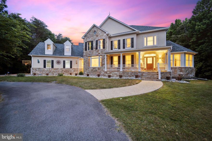 Welcome to this stunning custom-built home, featuring 5 bedrooms, 4 full bathrooms, and 2 half baths with over 8400 sq ft in the sought-after Patuxent Preserve community within the Crofton High School cluster. One of only three lots in the community permitted to raise horses, this  picturesque 11.28-acre lot is surrounded by protected woodlands, offering years of unparalleled privacy and bucolic views. Step into the grand two-story foyer with its elegant hardwood floors, which seamlessly flow into the open-concept main living area. The Chef’s kitchen is a true delight, boasting ample cabinetry, granite countertops, Jenn-Air cooktop and wall oven, and a two-tier island that overlooks the breakfast area and charming bay window. The expansive family room is an entertainer's dream with a cozy wood-burning fireplace adorned with stone surround and large windows that provide ample natural light and beautiful views of the rear yard. Host memorable dinner parties in the spacious formal dining room and living room nearby. The main level also features a quiet sitting room with a curved wall of windows overlooking the green space, a private office, two powder rooms, a mudroom, laundry room, and multiple access points to the rear deck, perfect for enjoying the outdoor oasis throughout the day. When ready to unwind, head up either of the two elegant staircases to the Owner’s Retreat where French doors lead to the spacious bedroom with tray ceiling, walk-in closet and a private balcony with tree-lined views, ideal for enjoying an evening drink under the stars. The luxurious en-suite bath boasts dual-sink vanity, separate shower and a jetted garden tub, providing the perfect setting for ultimate relaxation. Down the hall there are 3 additional bedrooms, two shared bathrooms and a bonus flex room that can serve as a 4th upper level bedroom, kid’s play area, in-law suite or gym with loads of storage space. Head to the lower level to enjoy a movie night in or entertain guests in the finished lower level rec room (2022) complete with a well-equipped kitchen (2023) boasting full-size appliances including an additional washer/dryer. Two bonus rooms with recessed lighting and an updated full bath are well-situated for an in-law suite, au pair space, gym, office or possible basement rental opportunity with walkout access to the rear yard. Plus tons of extra storage space for all of your long-term storage needs! Host a memorable summer BBQ on the large wraparound rear deck with patio, featuring bench swings, space for potential hot tub, and an expansive flat yard surrounded with mature trees. Plenty of parking for you and all of your guests via the circle driveway, attached three-car garage and extended driveway plus a built-in 50A charger for your electric car needs. Upgrades galore throughout this luxurious home including new roof (2024), 96 ground-mounted solar panels (2022), HVAC systems (2019-2022), UV air filtration system (2022), UV water purifier (2022), multi-stage well water filtration system (2022), water heater (2020), septic tank baffle (2023), attic air fan (2023) and exterior security lights (2024). Looking for green and reliable energy? Enjoy the fully-owned 31-kW solar panel array with a 30-year transferable warranty that will supply you with years of sustainable power. While SRECs do not automatically convey at the list price, SREC ownership transfer is negotiable and has provided approximately $1200 per year in bonus income. Enjoy the adjacent serene 40-acre meadow, 3 large ponds, walking paths and access to Patuxent River. Easy commute to Fort Meade, Annapolis, Baltimore, BWI airport and all that DC has to offer. Don’t miss this rare find!