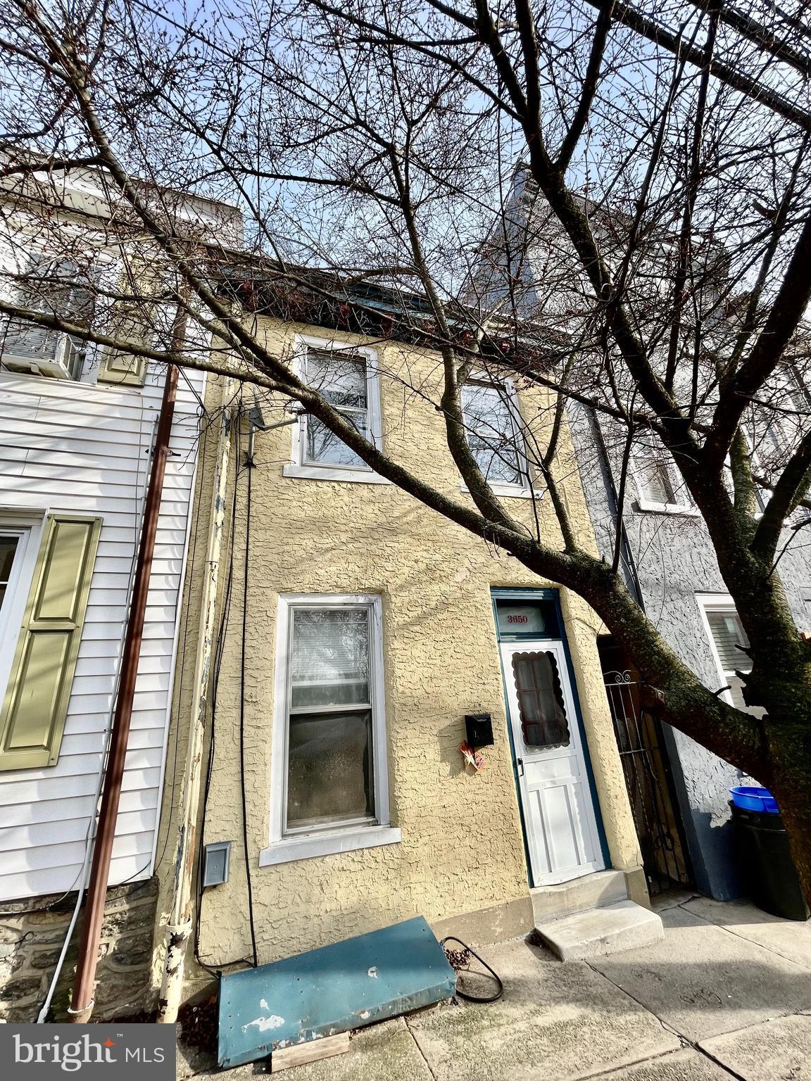 2 bedroom East Falls house with wood floors throughout, available for mid May occupancy. Upon entry you will find the living room with fireplace mantle. Moving back past the staircase is a large dining area, open to the airy kitchen. The kitchen is well equipped with a gas range, dishwasher and full size refrigerator. Out back find the yard and patio area which receives great direct sunlight. Upstairs are two spacious bedrooms and a full bath with large linen closet and claw foot tub. The unfinished basement is great for storage and holds the full size washer and dryer. Property will be freshly painted and touched up where needed. Pet friendly with no added fees or deposits. Strong credit required. Reach out for the video tour, showing requests and applications. Tenants pay all utilities.
