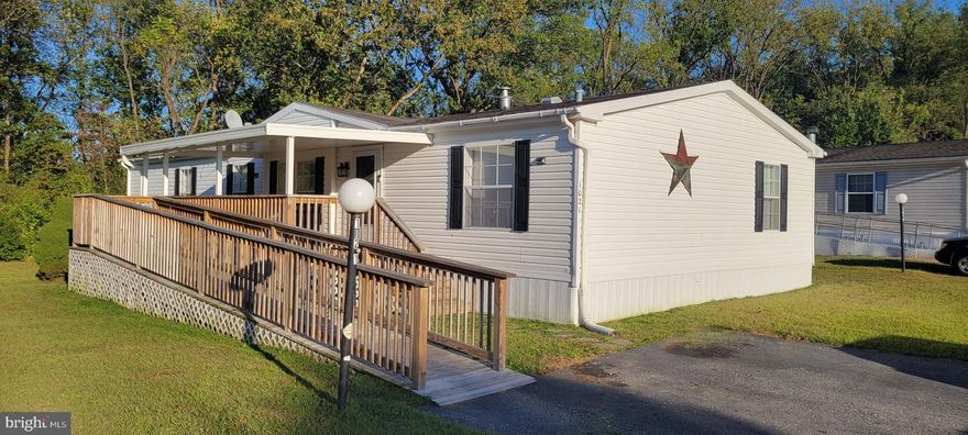 Nestled in the charming community of Pleasant Hills, this delightful double-wide manufactured home offers a perfect blend of comfort and functionality. Built in 1999, this well-maintained residence boasts 1,680 sq. ft. of inviting living space, ideal for creating lasting memories. Almost $50K invested in improvements and upgrades over the last 3 years (see attached documents for details). The spacious living room features a warm wood-burning fireplace, inviting you to unwind on chilly evenings. Natural light pours in through thoughtfully placed window treatments, enhancing the home's welcoming ambiance. The kitchen is equipped with modern appliances, including a built-in microwave, gas range, and dishwasher, making meal prep a breeze. Enjoy the convenience of a main-floor laundry area with a washer and dryer included. Retreat to the primary suite, complete with a luxurious soaking tub and a separate stall shower in the en-suite bathroom, along with a generous walk-in closet. Two additional bedrooms provide ample space for guests or a home office. Be sure to read the extensive list of improvements made to this home over the last three years.  Outside, relax on the spacious covered porch or utilize the shed for extra storage. With ring security at the front door included, peace of mind is assured. Parking is a breeze with a driveway accommodating two vehicles. This home is not just a place to live; it’s a place to thrive. Experience the warmth and comfort of this inviting residence in a community that feels like home.