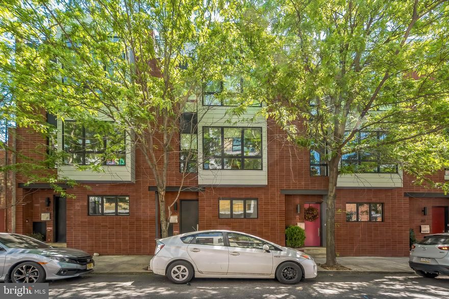 Stunning Contemporary Townhome with Two-Car Garage in the Heart of Northern Liberties!

Welcome to this beautifully designed 3-bedroom, 3.5-bath townhome offering modern luxury, exceptional space, and unbeatable location. Featuring two private garage parking spaces, two outdoor decks, and sleek contemporary finishes throughout, this home truly checks every box.

Venture inside to a spacious entryway complete with a custom built-in mudroom and an entire wall of closet space—perfect for staying organized. There is also a half bathroom, coat closet and a convenient access to the private two-car covered garage.

Up the first flight of stairs, the open-concept main level dazzles with natural light and seamless flow between the living, dining, and kitchen areas. The elegant dining space, surrounded by oversized windows, is ideal for hosting gatherings. The chef-inspired kitchen boasts high-end stainless-steel appliances, a wine fridge, modern range hood, breakfast bar seating, and stylish cabinetry. Relax in the sun-drenched living room featuring a cozy fireplace and direct access to a rear deck—perfect for grilling or entertaining outdoors.

The third floor offers two spacious bedrooms and two bathrooms, one being the primary suite. The luxurious primary bedroom includes a walk-in closet and a spa-like en-suite bath featuring dual vanities, a glass-enclosed shower, and a soaking tub. The additional bedroom is generously sized with large windows, ample closet space, and beautiful wood flooring.

At the top level, enjoy a versatile loft-style living area complete with a wet bar and access to a private rooftop deck offering stunning skyline views—ideal for relaxing or entertaining under the stars. Plus an additional bedroom and full hall bath perfect for owners and guests alike. The home also includes a stackable washer and dryer, dual newer HVAC systems and custom blinds throughout. Not to mention, the additional gravel space in the rear of the home perfect for overflow parking for owners and guests!

Located in the vibrant and sought-after Northern Liberties neighborhood, you'll be only a few blocks away from top-rated restaurants, coffee shops, boutiques, grocery stores, and public transportation. Whether you're enjoying brunch at cafe Le Maude or Honey's, relaxing in Liberty Lands park, or exploring the lively nightlife, everything you need is just outside your door.

Don't miss this opportunity to own a one-of-a-kind home in one of Philadelphia’s most exciting neighborhoods. Schedule your private tour today!