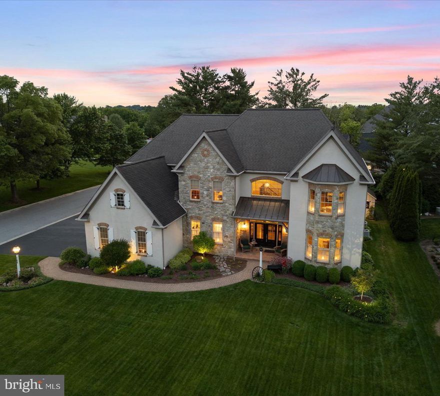 Rates are dropping, don't miss this opportunity. This remarkable Bent Creek home has been cherished by it's original owner since it was built in 2004.  An exquisite Costello-build, this dream home offers over 7,400 sq ft of meticulously maintained living space, and is nestled in the most sought-after gated golf course community—Bent Creek. Every inch of this residence reflects thoughtful design and high-end craftsmanship, from the elegant 10-foot ceilings to the gleaming luxurious hardwood floors throughout.
Step into the heart of the home where coffered ceilings crown the spacious kitchen and living areas, creating a grand yet inviting atmosphere. The kitchen is a true culinary masterpiece—an elite gourmet space featuring stunning granite countertops, a double oven, and a striking custom copper hood vent. Thoughtfully designed with every imaginable convenience. The main family room features a custom wet bar and a beautiful fireplace, perfect for entertaining or relaxing in comfort. An additional fireplace in the primary suite adds warmth and charm to your private retreat. The primary en suite bathroom is a spa-like haven, while each of the four additional bedrooms enjoys the convenience and style of Jack-and-Jill bathrooms. Crown molding flows seamlessly throughout the home, and the dramatic staircase makes a striking architectural statement.
Enjoy working from home in the first-floor office, and host elegant dinners beneath the glowing tray ceiling in the formal dining room. Outside, the private backyard oasis is ideal for all-season enjoyment with a beautiful brick fireplace, sprinkler system, and plenty of space for outdoor activities.
Don't miss your chance to be in Lancaster's premier gated community with a newly upgraded golf course, resort-style amenities, and unparalleled privacy.