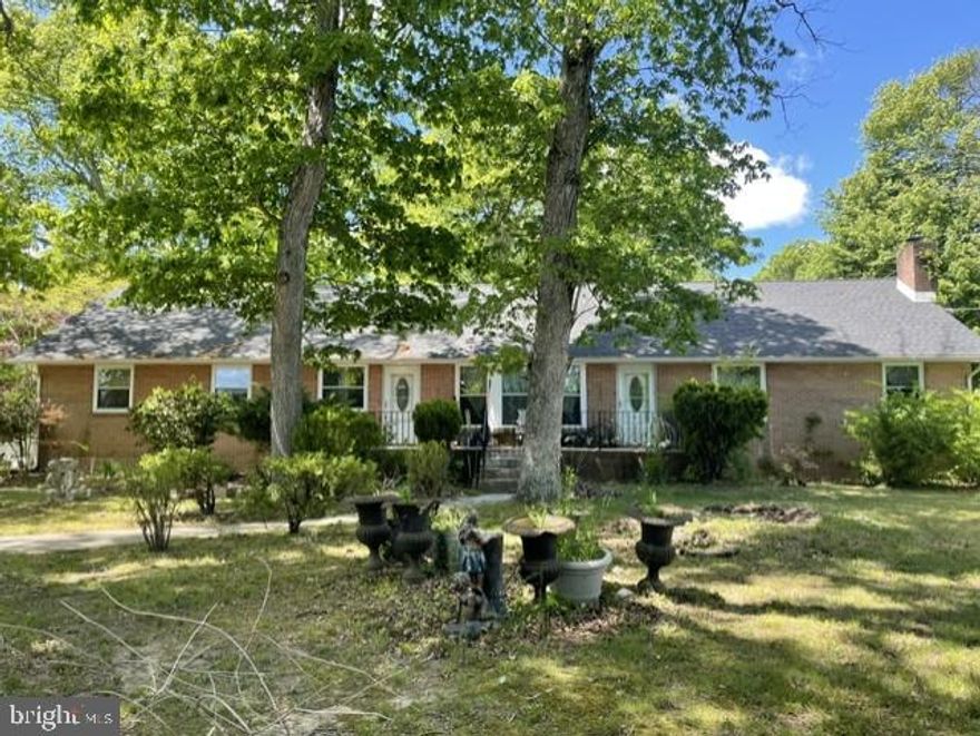 INVESTOR ALERT! Quiet country living, just outside of the City of Dover limits. This spacious brick ranch home, situated on nearly 3/4 acres and surrounded by large shade trees, has a finished basement and oversized two-car garage. The home is in need of some cosmetic "TLC" but offers so much potential! This home has 5 bedrooms and 3.5 baths. Two additional rooms in the finished basement have been used as bedrooms in previous years. The large eat in kitchen is perfect for entertaining, w/ white cabinetry, laminate flooring, pantry with all appliances remaining. Just off of the kitchen you'll notice a roomy dining area and family room with access to the rear of the home. The generously sized living room w/ ceiling fan has a lovely, seated bay window providing plenty of natural light. Making your way through the first floor of the home, you'll find two nicely sized bedrooms w/ ceiling fans and a full hall bath w/ soaker tub. The main bedroom w/ huge walk-in closet and ceiling fan offers a spacious full bath w/soaker tub and tiled surround, separate seated shower w/ glass doors and linen closet. The primary bedroom has private access to the laundry area, sunporch and dining/family room areas. Upstairs is the 4th bedroom w/ half bath and a large attic for all your storage needs. Making your way to the lower level of the home you'll find the expansive finished basement w/ LVP flooring and a 5th bedroom w/ egress window. There is also a stone fireplace, but it has been closed off. It MAY be able to be reopened but the seller is not certain. In 2002 the home had a new roof installed, new windows, HVAC, exterior doors and gutters. The entire side and backyard have been enclosed with a white vinyl privacy fence. This area is massive offering tons of space. Bring your boat, trailer maybe your RV even, plenty of parking! The home is being sold strictly AS IS. Seller will make no repairs. The home is in need of a new septic so no FHA, USDA or VA buyers please. Inspections will be for informational purposes only. Buyer is responsible for all due diligence, repairs and certifications. This home has so much to offer! With some "TLC" this diamond could sparkle once again!