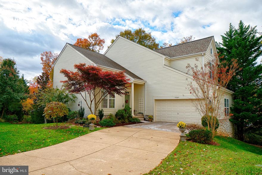 Set on .17 acres of beautifully landscaped grounds, this Barrington Home, the 2nd largest model, boasts a total of  4400sqft (including garage). This well maintained home features: A 2-story foyer and living room; An Upgraded Kitchen with granite countertop, stainless steel appliances and a breakfast nook overlooking the beautifully landscaped yard; Family Room with gas fireplace; Dedicated library/office with French Doors  Master Suite with a large walk-in closet; An Updated Bath with Granite, Thomasville cabinetry & Kohler fixtures; Second bedroom can be made into 2 bedrooms; A walk-out lower level with two separate areas for recreation plus a bedroom, a full bath, storage under the stairs, and a large storage room. Please note that while this home is in Reston, this community is NOT part of the Reston HOA.  List of Updates and Year:  HOT WATER HEATER (2017); CARPET (2019); LG WASHER & DRYER (2016); TRANE FURNACE A/C (2011); ROOF (2011); Merrifield LANDSCAPING  (2011); HARDSCAPE (2011); KITCHEN Remodel (2013   2007); Installed WOOD FLOORS on the second level (2007);  MASTER BATH Remodel (2007).