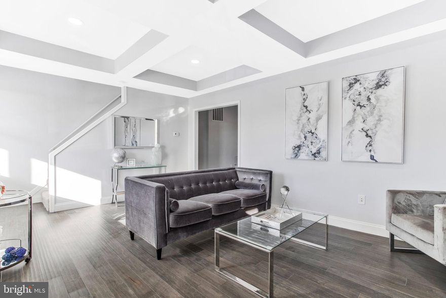 Gorgeous nicely appointed spacious home. Enter this updated gem through the main level where you will find engineered hardwood flooring, tray ceilings, a tiled fireplace, a spacious living room, a nice open kitchen, a main-level bedroom, a spacious bath, and a laundry room. The updated kitchen features stainless steel appliances a large peninsula with sparkling quartz countertops, a luxurious backsplash that highlights beautiful white soft-close cabinets, and a separate dining area. The upper level is carpeted and boasts a large master bedroom with en-suite and three other generously sized light-filled bedrooms. Enjoy the spacious covered front porch and large fenced-in rear yard off the kitchen for entertainment. The unfinished basement is large and has plenty of room for storage and flexibility.