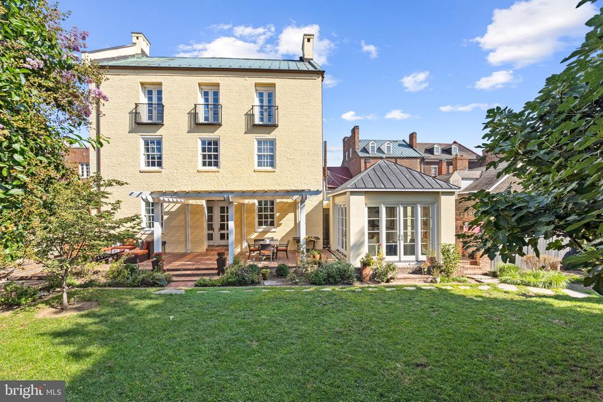 Welcome to 2 Swifts Alley, an exquisite piece of Alexandria's history beautifully melded with modern luxury. This distinguished 4-bedroom, 4.5-bathroom home offers a unique blend of character, history, privacy, and contemporary comforts, making it a true gem in the heart of Old Town. This remarkable property, circa 1780, was once a tobacco warehouse, and its rich heritage is evident in the original wood beams that grace the home's interior. The historic character is seamlessly combined with modern amenities to provide a comfortable and elegant living experience. With over 5,300 square feet of finished living space, this home offers ample room for both relaxation and entertainment. Hardwood floors, recessed lighting and multiple fireplaces enhance the ambiance, while the oversized windows and 12-foot-high ceilings infuse each room with natural light. The renovated kitchen (2019) is a culinary enthusiast's dream, while the renovated primary bath (2019) and guest bathroom provide a touch of contemporary luxury. A reconfigured third level is perfect for guests or families (imagine a separate floor just for the kids or guests!) with two additional bedrooms, renovated bath, and large upper-level family room. The breakfast room, with its expansive windows, offers a delightful space to start your day with a view of the gardens. The lower level unveils versatile spaces including a  recreation room with grand fireplace and stone floors, a dedicated gym area, and lower-level pantry that can be reimagined into your dream wine cellar. Nestled on a 5,750 square foot lot, this property presents a large yard perfect for outdoor gatherings and recreational activities. Imagine hosting summer barbecues, playing fetch with the family dog or enjoying a leisurely game of croquet in this serene space. Convenience is key, with just one block separating you from the charming shops and restaurants of Old Town Alexandria, City Hall, and the Saturday Farmer's Market. Commuting is a breeze with easy access to major routes, public transport - being less than a mile away from the King Street Metro and Amtrak station. National Harbor, Amazon's HQ2, Washington DC, and more are all within a short drive. A valuable bonus in Old Town, this property offers one parking spot for your convenience. Don't miss your opportunity to own a piece of Alexandria's history while enjoying all the modern comforts this home has to offer.