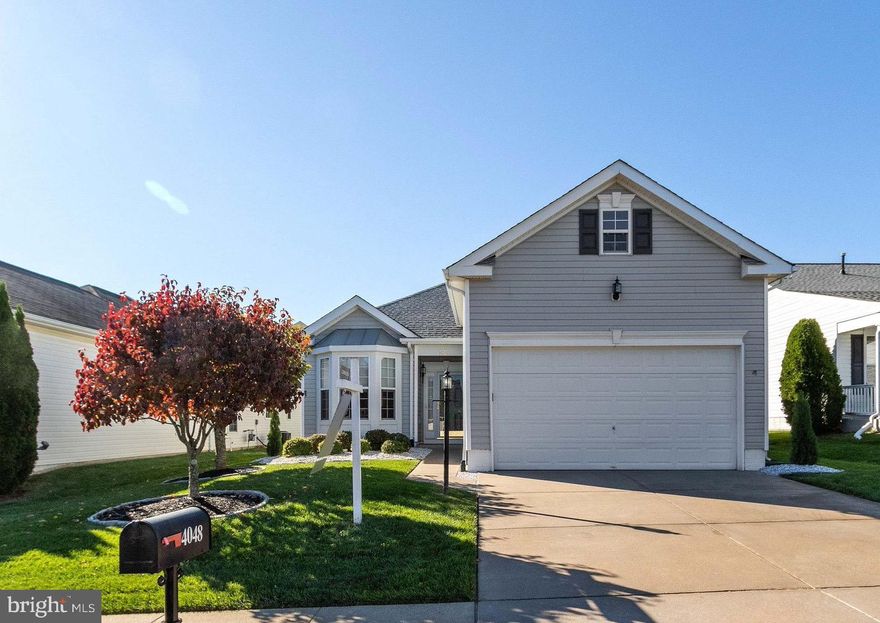 Your next home awaits you in this desirable 55+ Active Adult gated community at Four Seasons in Historic Virginia! This unique single level, 2-bedroom, 2 bath, 2 car garage Wentworth home has $89,000 in upgrades!!  As you enter notice the 9ft ceilings throughout that provide an open and airy feeling.  The home features a spacious eat-in kitchen with Dura Tile Ceramic Flooring (2006), stainless steel appliances and 42” Medium Oak Cabinets.  The Dining Room and Living Room feature crown molding.  The living room is enhanced with recessed lights, surround sound and a gas fireplace.  Double glass doors lead to the four-season Sun Room with vaulted ceiling and ceiling fan. Enjoy your coffee there or step out onto the custom stamped concrete patio (from Greystone 2005) on a cool fall morning.  Hardwood floors (Rio Mirage Flooring Red Oak Cashmere Finish, no scratch from Carpet and Floor Outlet) flow from Foyer to Sunroom and into the spacious Primary Bedroom, which boasts a large walk in closet.  The ensuite features double sinks, tile flooring, shower and separate tub. Brand new carpeting in the 2nd bedroom!
Other upgrades include Fresh paint, HVAC with UV Air Purifier upgraded to Trane in 2013, Custom and professionally installed Blinds from Next Day Blinds and upgraded window treatments.  New Roof with Architectural Shingles and 50-year warranty installed in 2018, professional landscaping, and inground lawn irrigation system, to name a few.  Travel and never worry, with the whole home backup natural gas generator that was replaced in 2020 with a 7-year warranty, to keep systems running in the event of an electric power outage. A big plus is the reasonable utility costs!  New Kitchen Aid Refrigerator (2020).  New Rheem 50-gallon electric hot water heater installed in 2020. Home has security monitoring from Ashwood Security (Buyer is responsible to continue service if they choose to).  Above garage there is storage or it can be turned into a bonus room/office.  The magnificent 21,500 sq. ft clubhouse, indoor and outdoor pools, ballroom, fitness center, billiards, game rooms, cyber café, classrooms, bocce ball, tennis, putting green, walking trail all shout out to an active social calendar!!